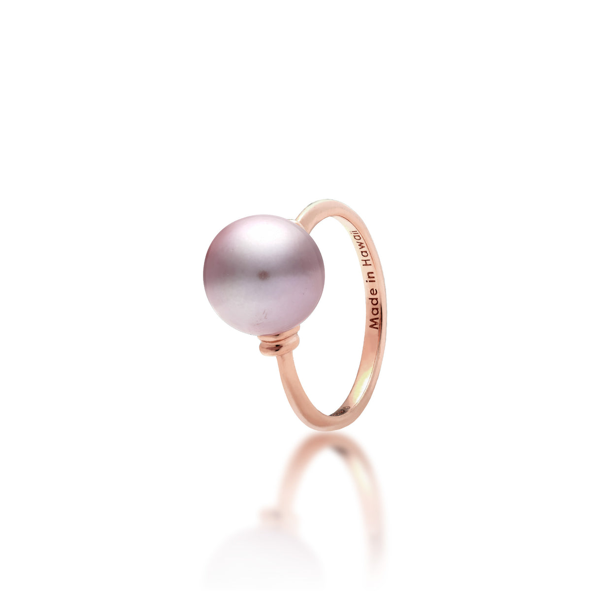 A 14k rose gold ring with a lilac freshwater pearl and raised divot accents in rose gold on each side of the pearl, shown on a white background