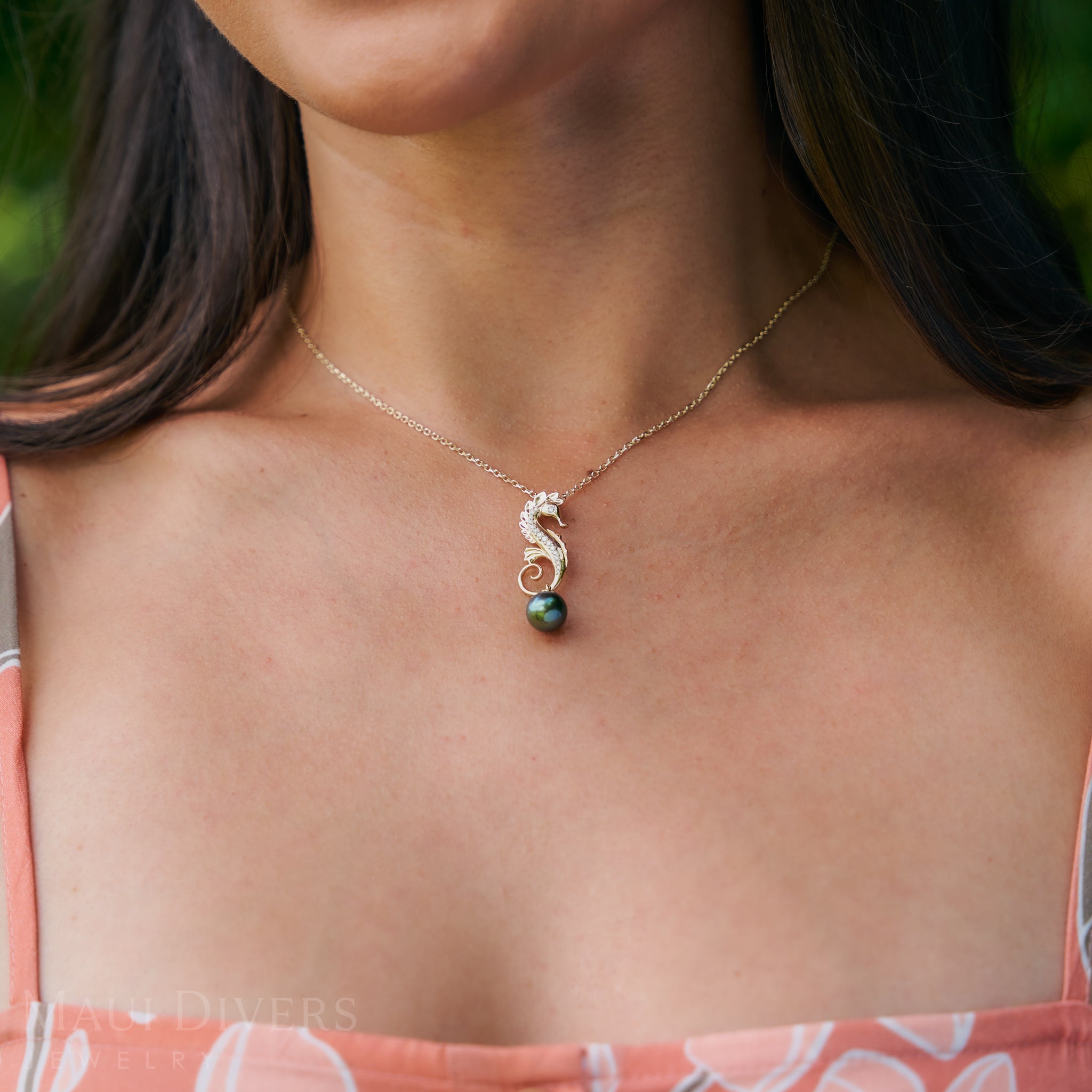 Close up of 1.0mm Cable Chain in 14k Yellow Gold with a seahorse pendant on a woman's neckline