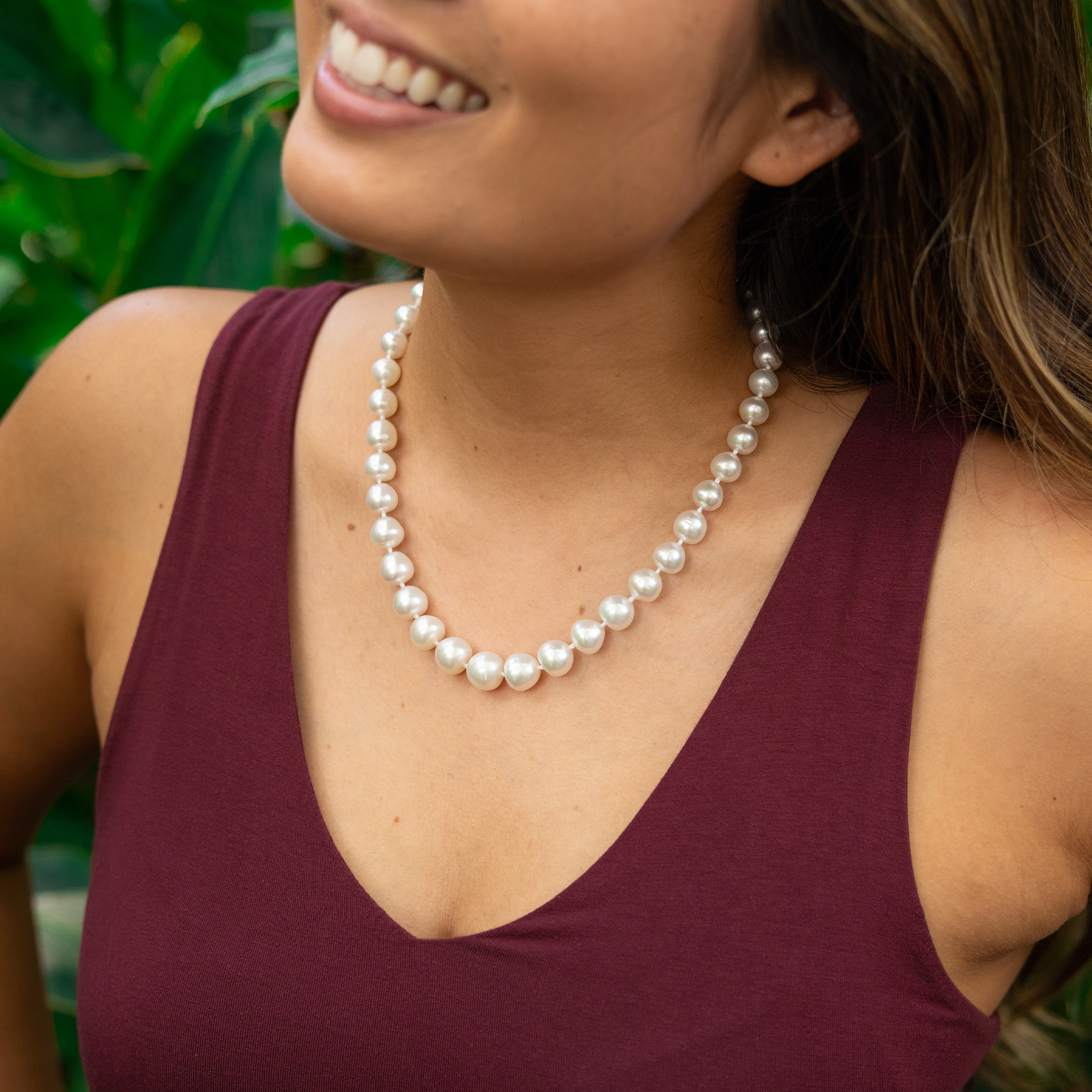 Close up of a woman wearing an 18-19" 9-10mm South Sea White Pearl Strand with Magnetic Clasp in Gold