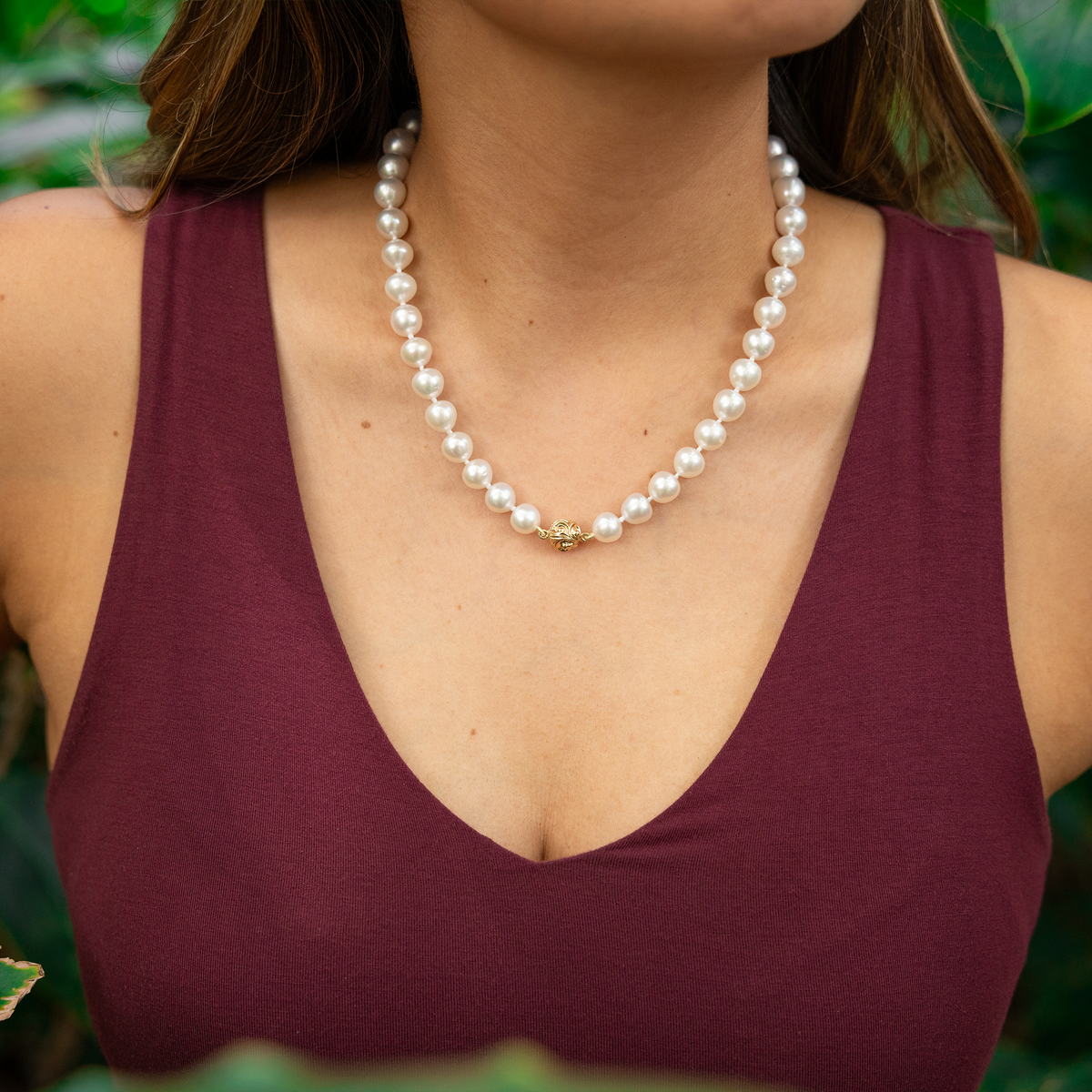 Close up of a woman's chest wearing an 18-19" 9-10mm South Sea White Pearl Strand with Magnetic Clasp in Gold