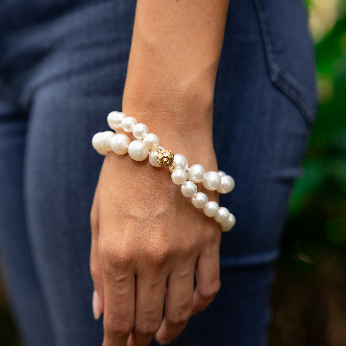 South Sea White Pearl Strand with Magnetic Clasp in Gold wrapped twice around a woman's wrist