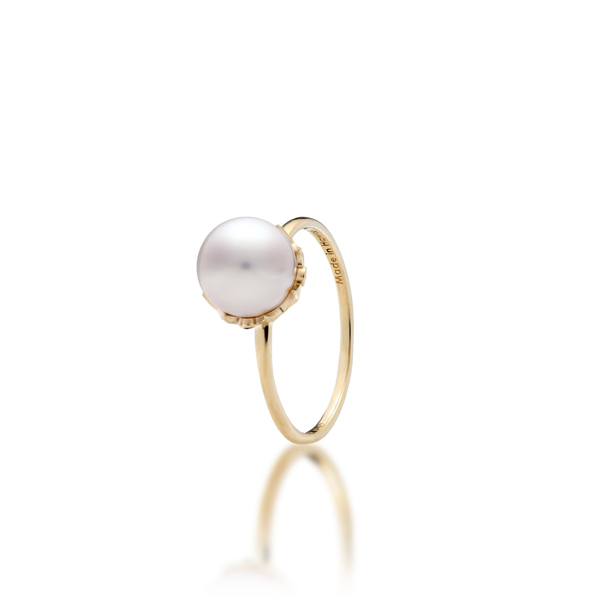 An 8mm Akoya white pearl ring in 14k yellow gold with a Hawaiian quilted star design with diamonds around the crown, shown on a white background