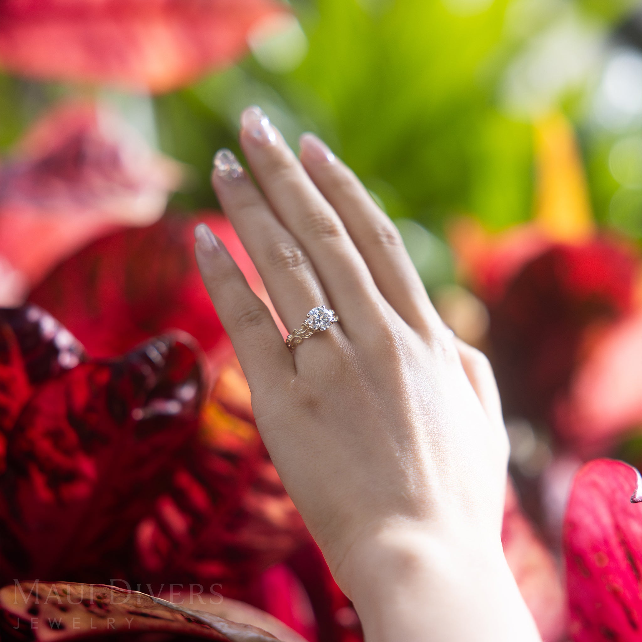 Hand wearing a Living Heirloom Solitaire Lab Grown Diamond Ring in Gold on a blurred natural background