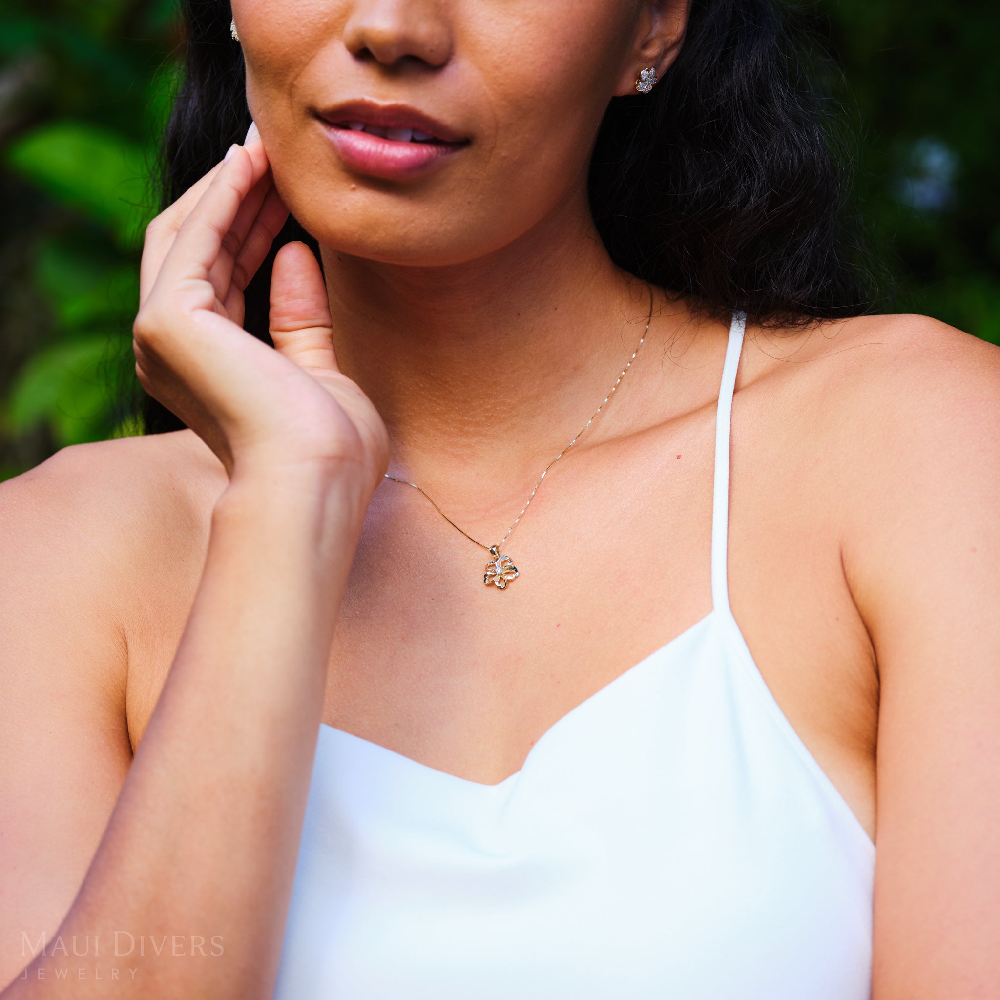Woman wearing a cut-out design Plumeria Necklace in 14k Yellow Gold
