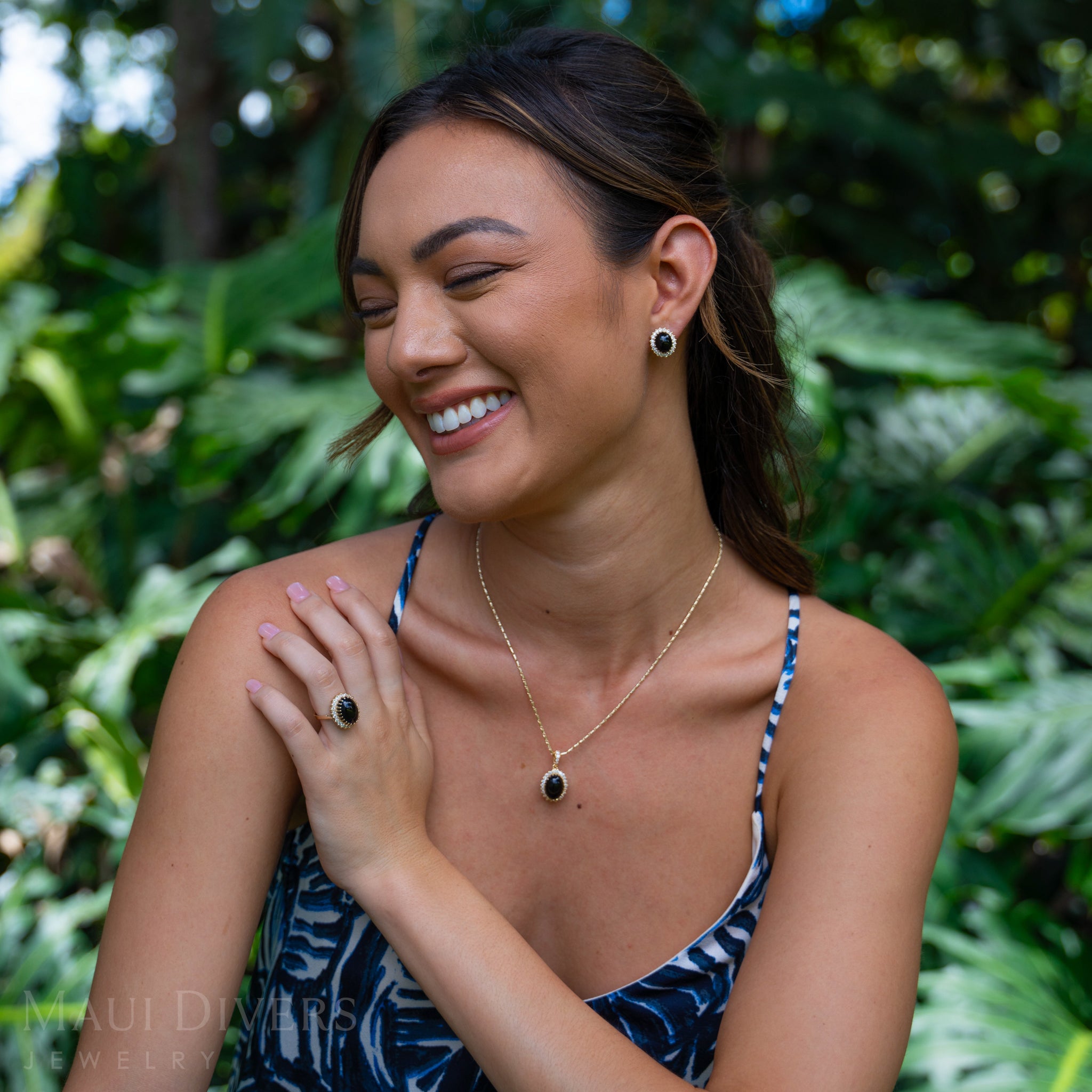 Woman wearing a Princess Ka‘iulani Hawaiian Black Coral Ring and pendant in Gold with Diamonds
