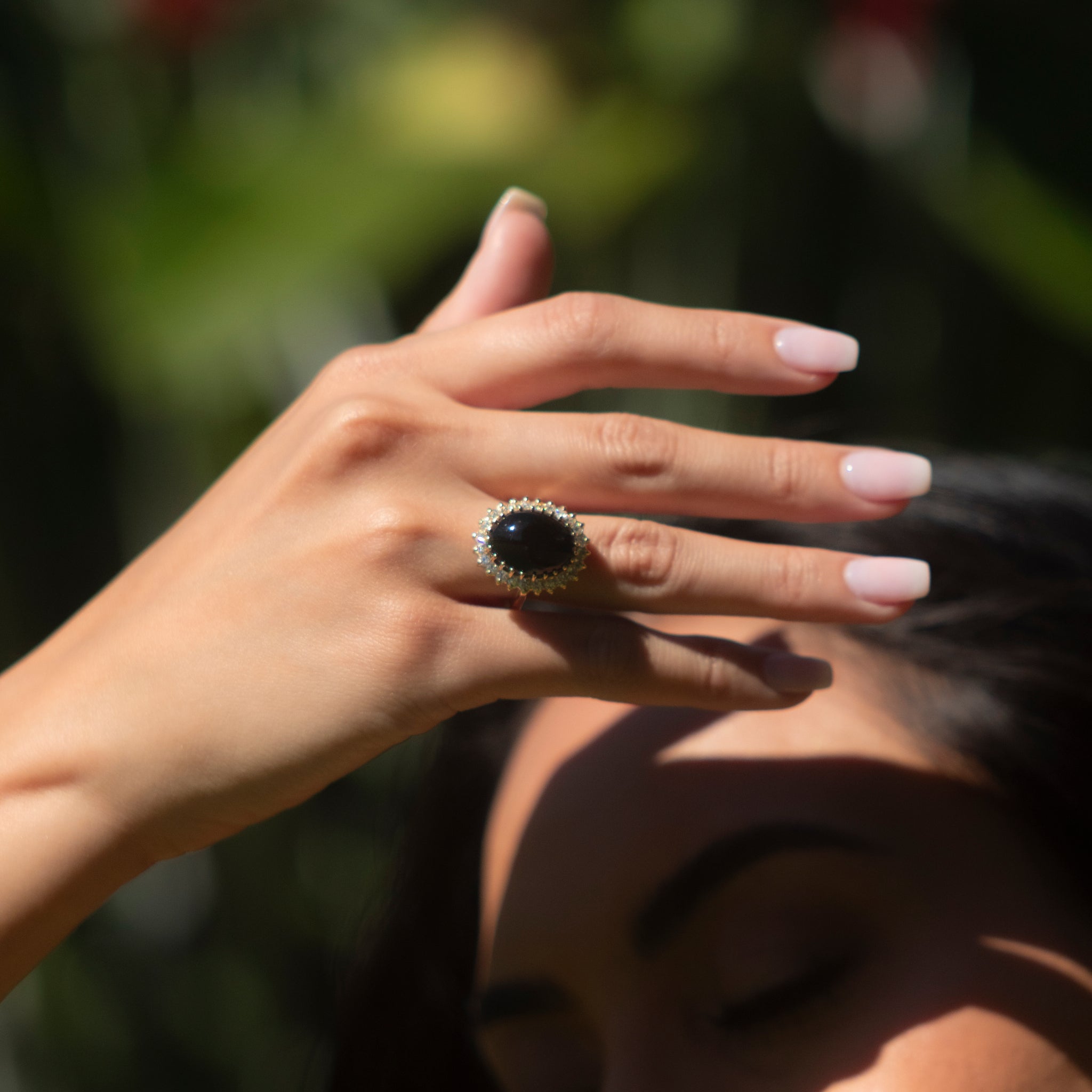 Womanʻs hand wearing Princess Ka‘iulani Hawaiian Black Coral Ring in Gold with Diamonds