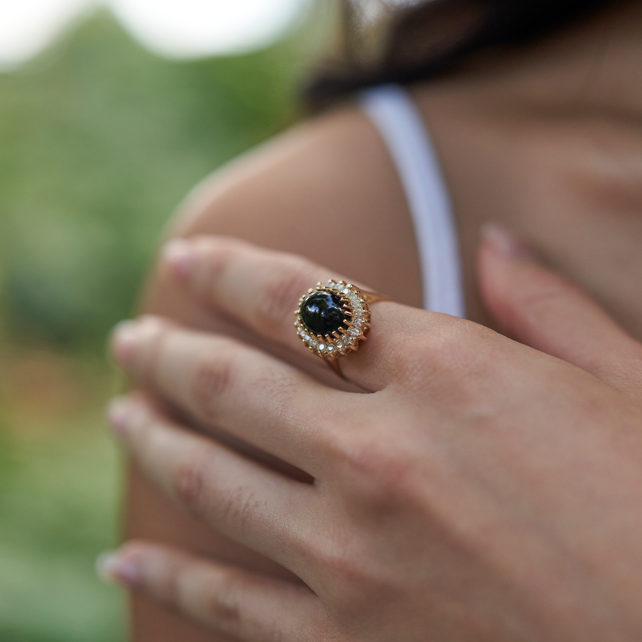 Close up of hand wearing Princess Ka‘iulani Hawaiian Black Coral Ring in Gold with Diamonds