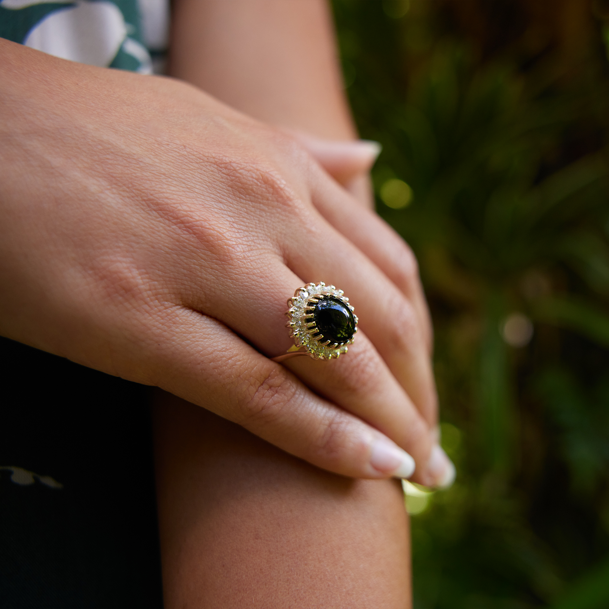 Close up of hand wearing Princess Ka‘iulani Hawaiian Black Coral Ring in Gold with Diamonds