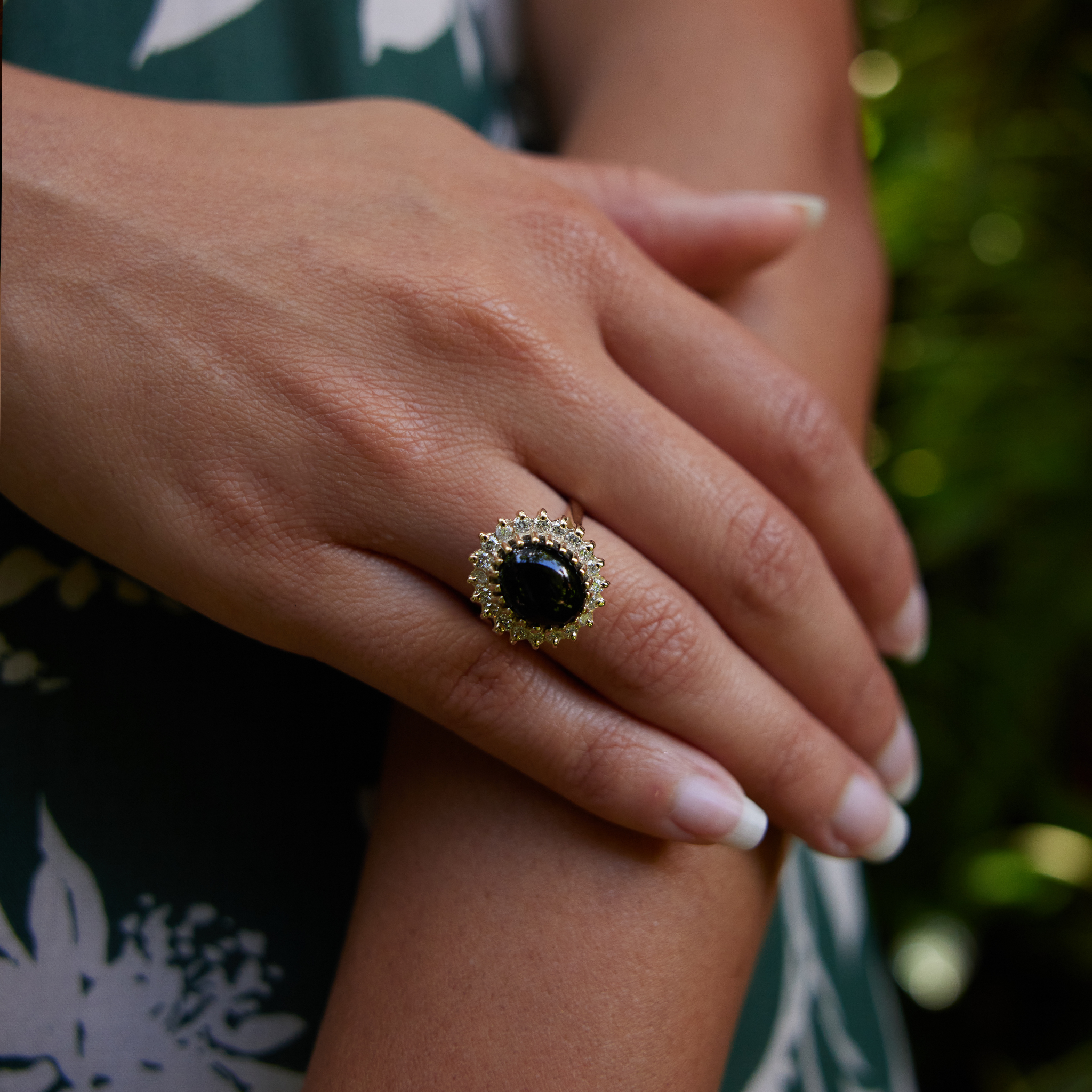 Close up of hand wearing Princess Ka‘iulani Hawaiian Black Coral Ring in Gold with Diamonds