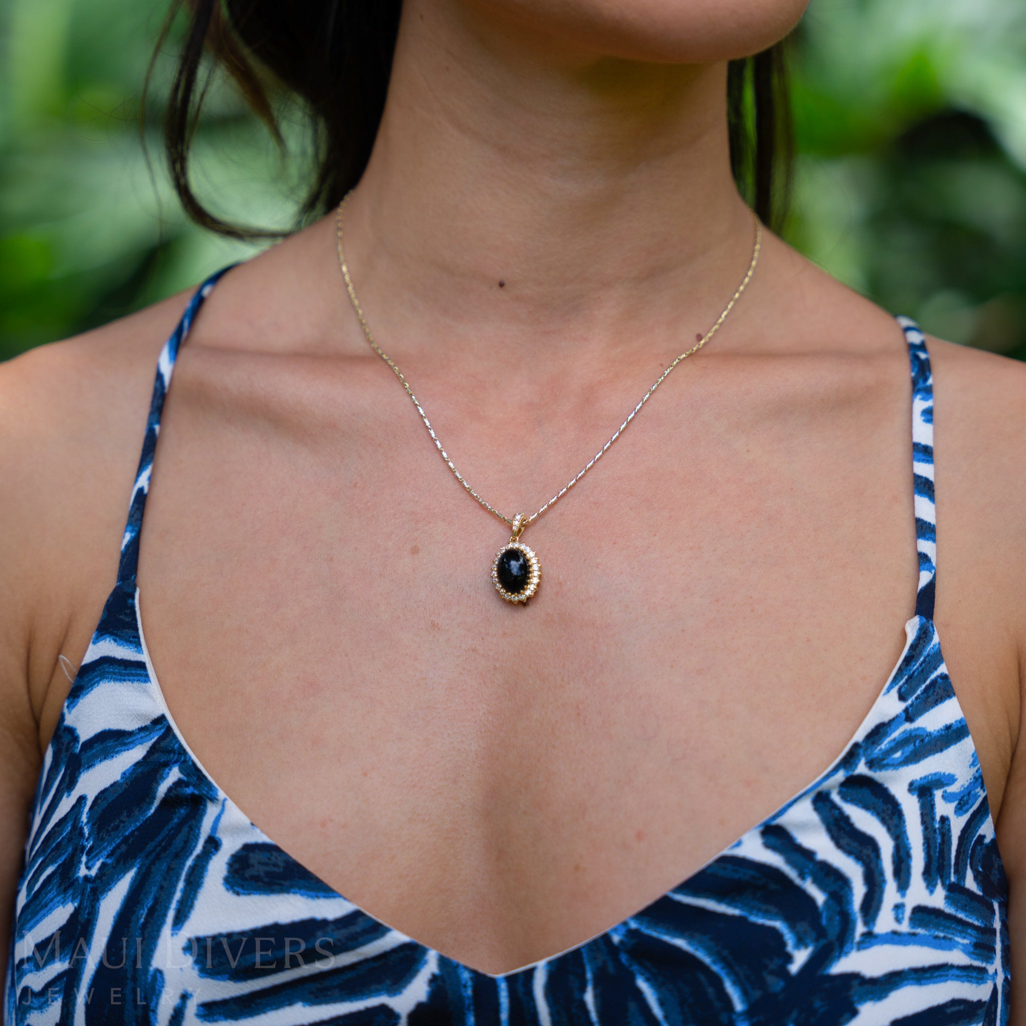Woman wearing Princess Ka‘iulani Black Coral Pendant in Gold with Diamonds outdoors