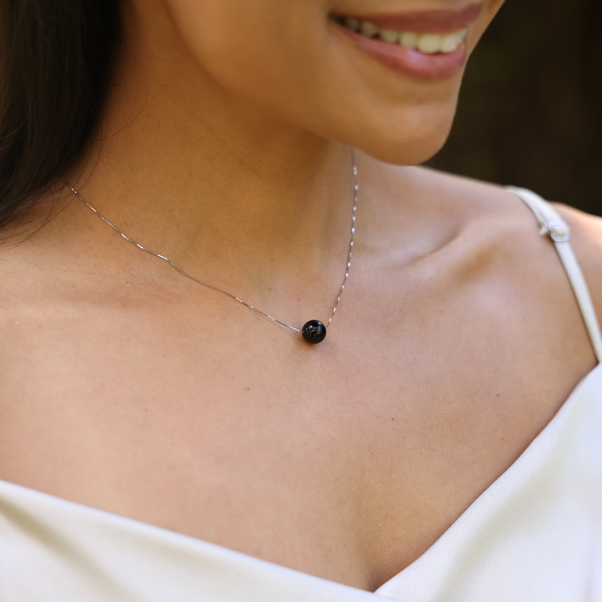 16" Hawaiian Black Coral Necklace in White Gold on woman's neckline