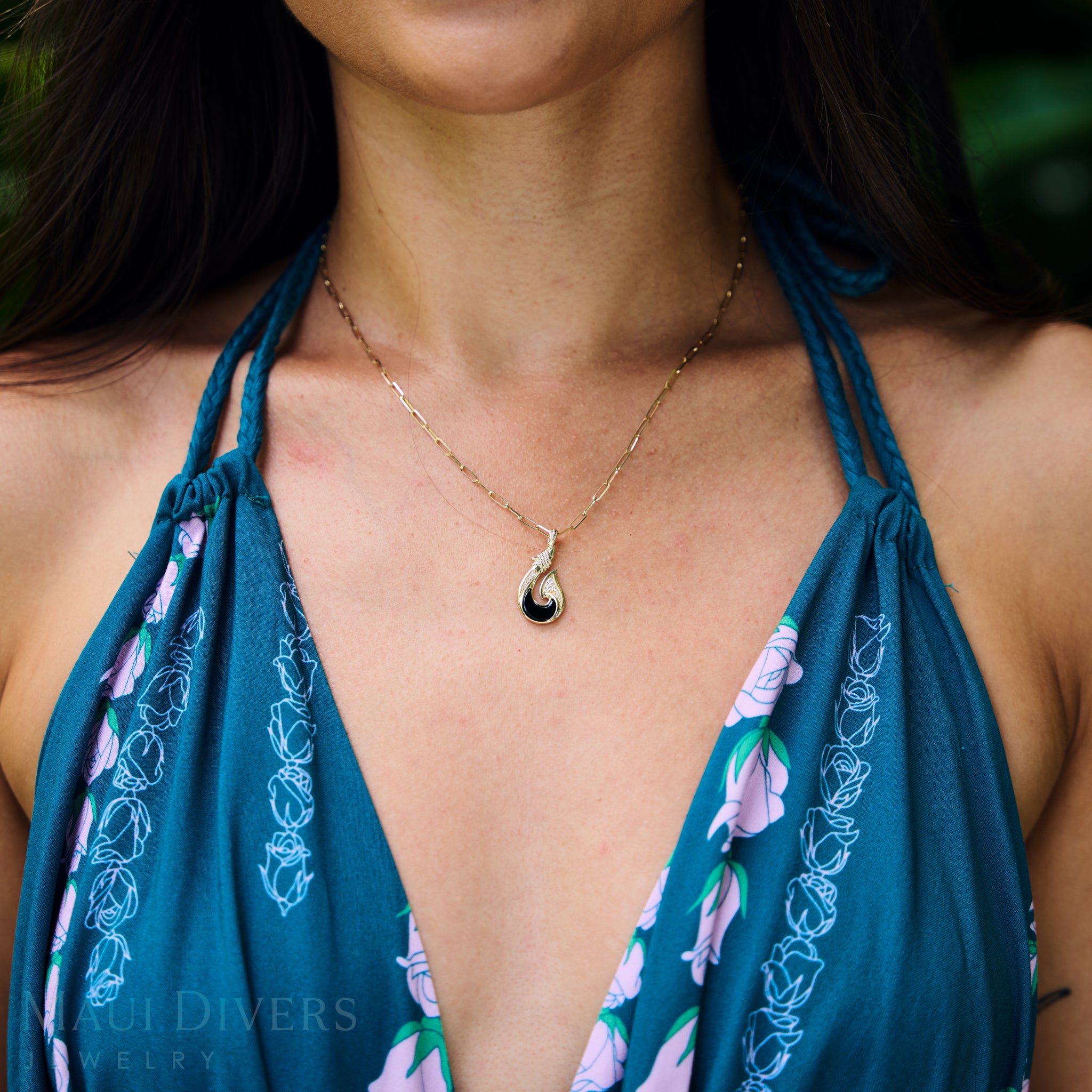 Close up of 2mm Paperclip Chain in Gold on a woman's chest wearing a blue floral dress