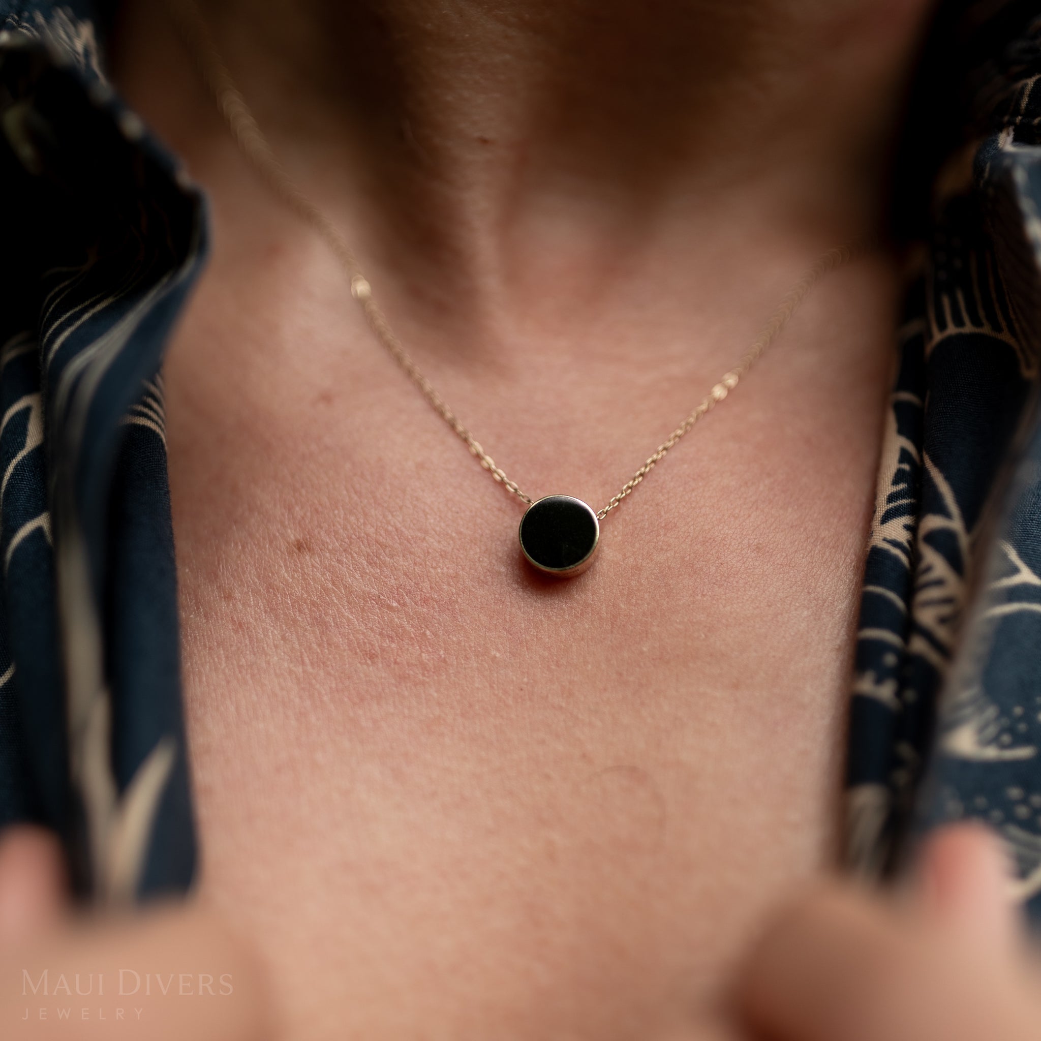 Close up of Eclipse Flipside Black Coral & Mother of Pearl Necklace in Gold on man's neckline
