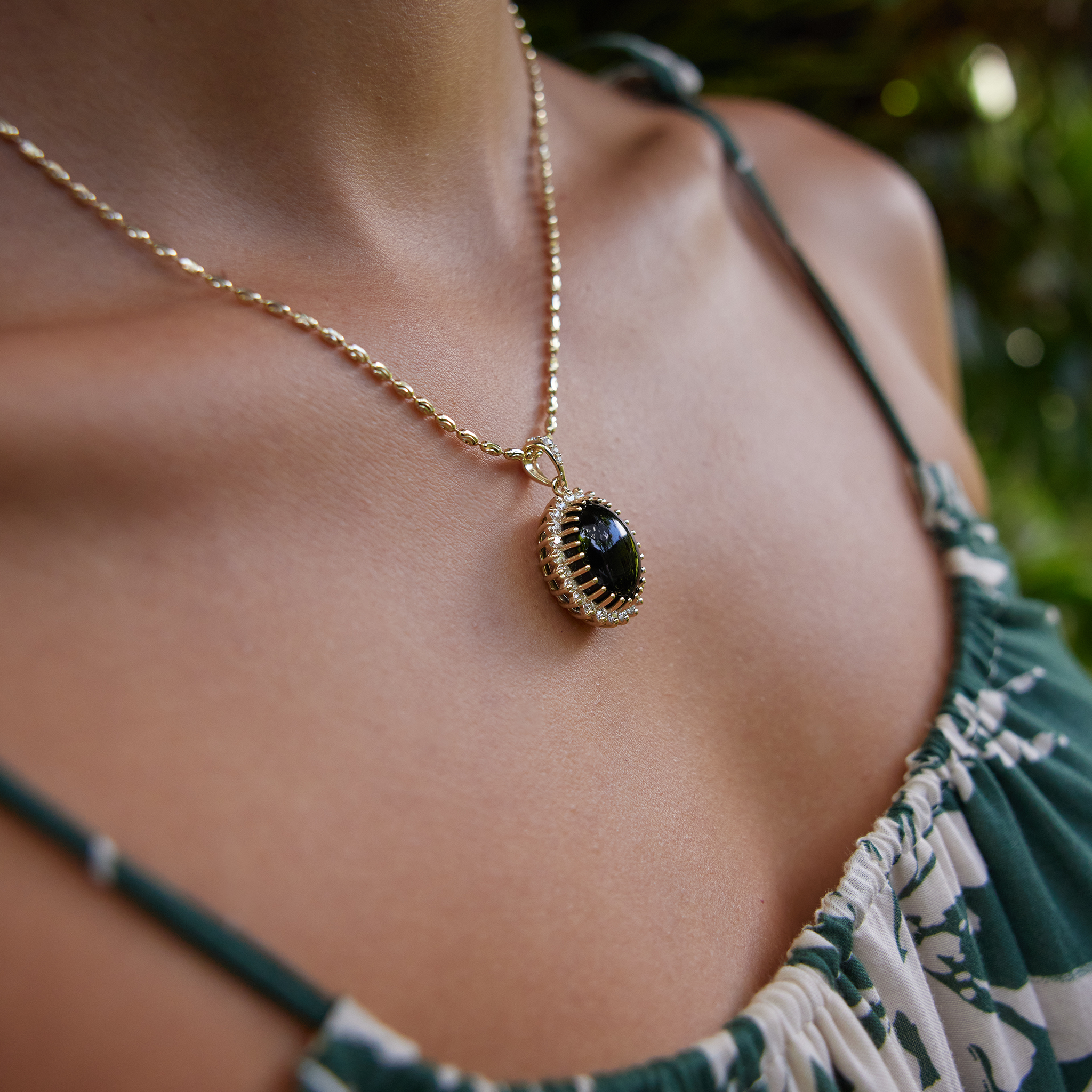 Close up side view of Princess Ka‘iulani Black Coral Pendant in Gold with Diamonds on neckline