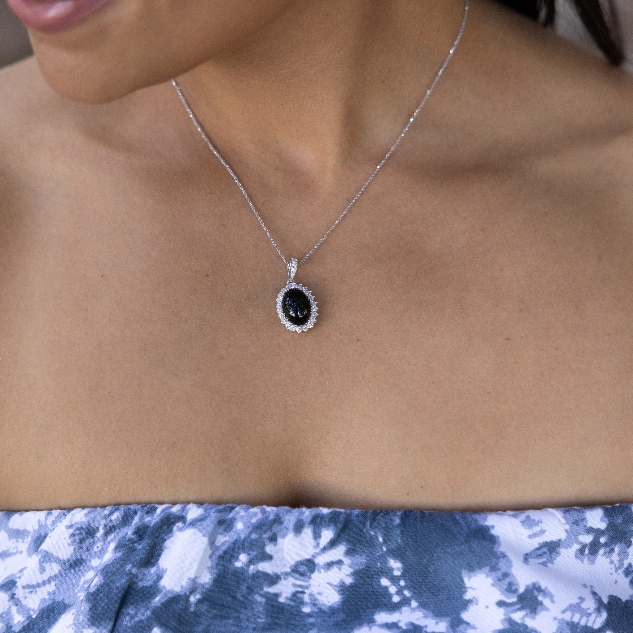 Close up of Princess Ka‘iulani Black Coral Pendant in White Gold with Diamonds on woman's chest