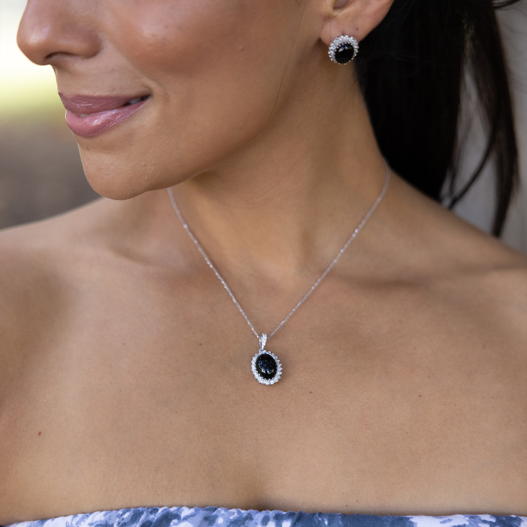 Close up of woman wearing Princess Ka‘iulani Black Coral Pendant and earrings in White Gold with Diamonds