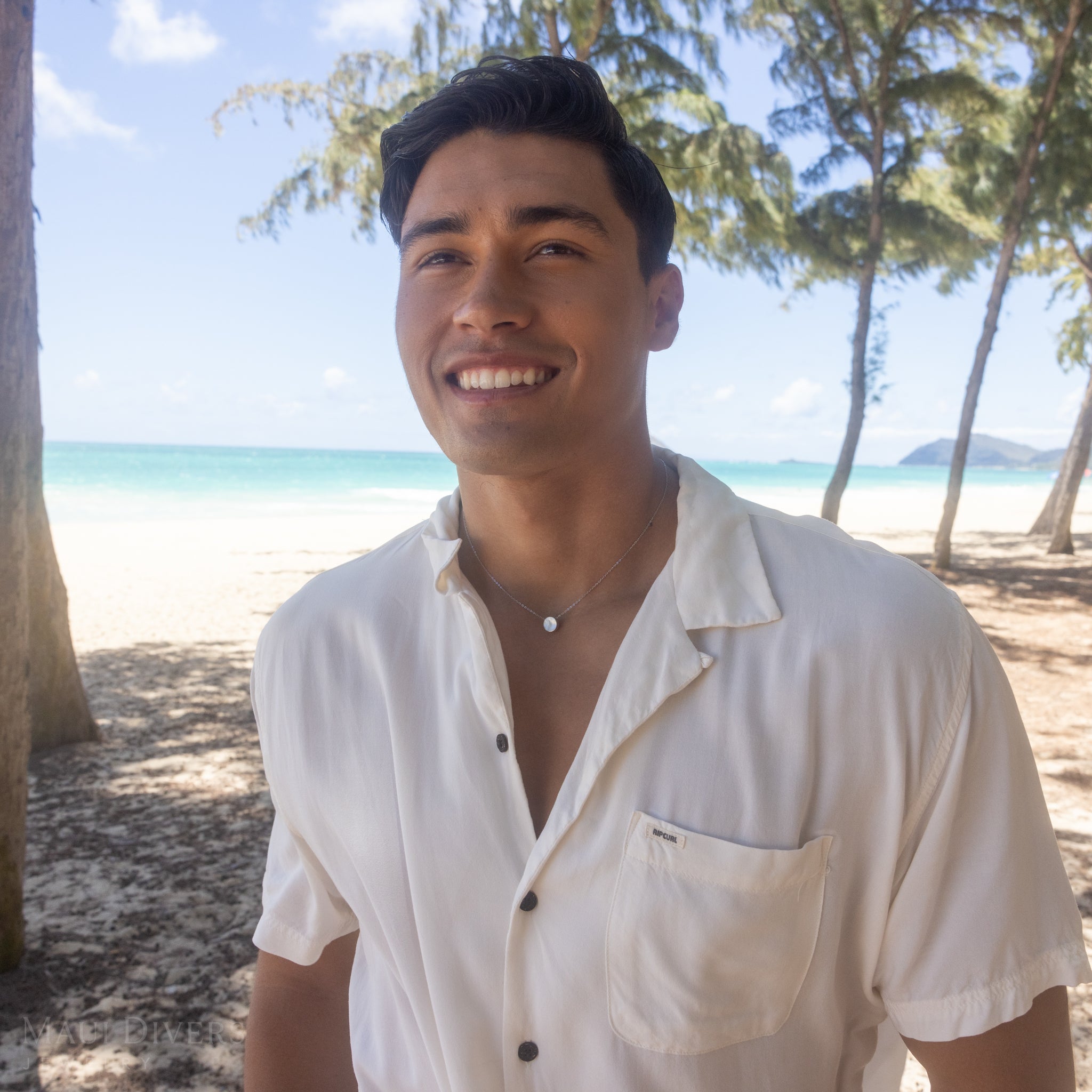 Man on beach wearing Eclipse Flipside White Mother of Pearl Necklace in White Gold