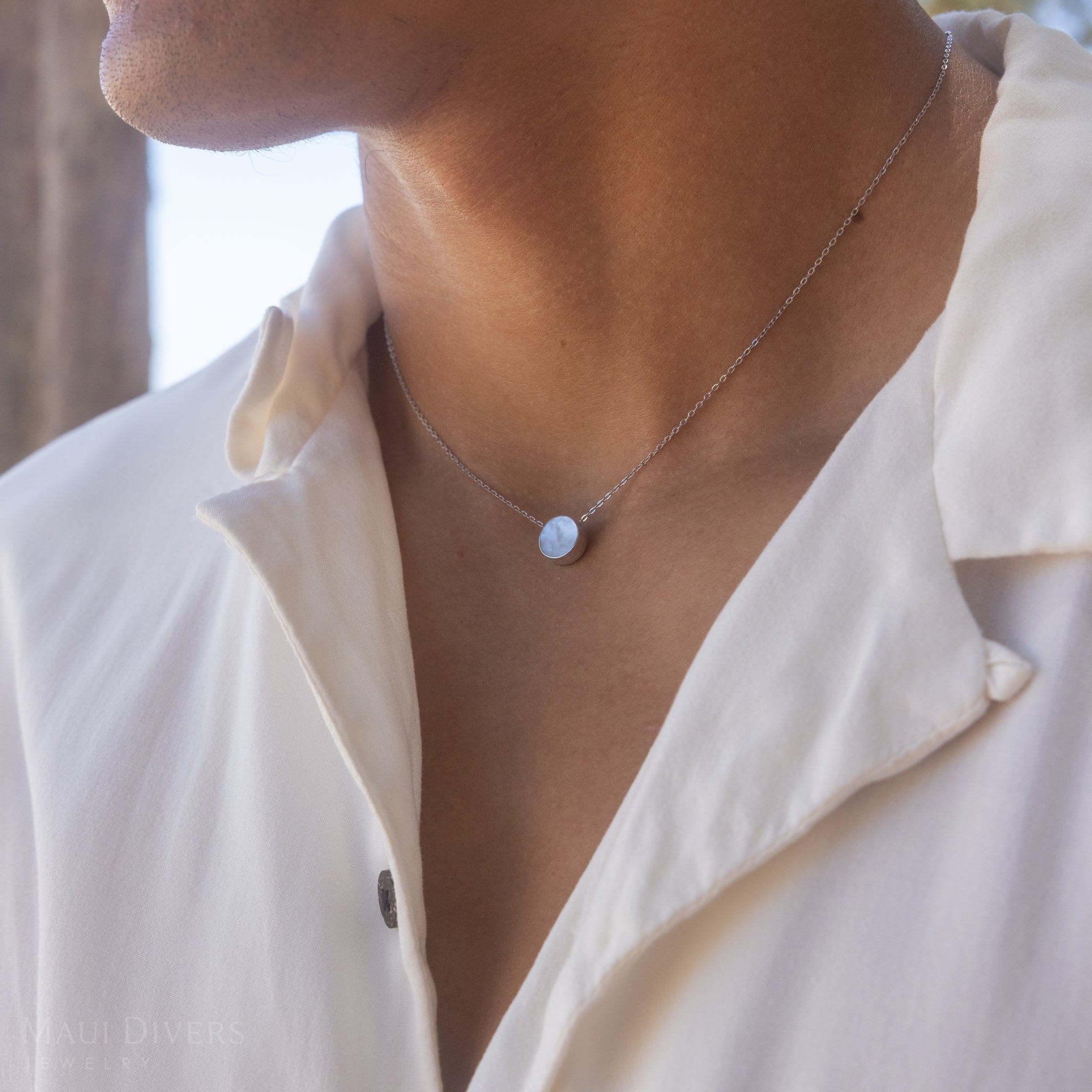 Person on beach wearing Eclipse Flipside White Mother of Pearl Necklace in White Gold