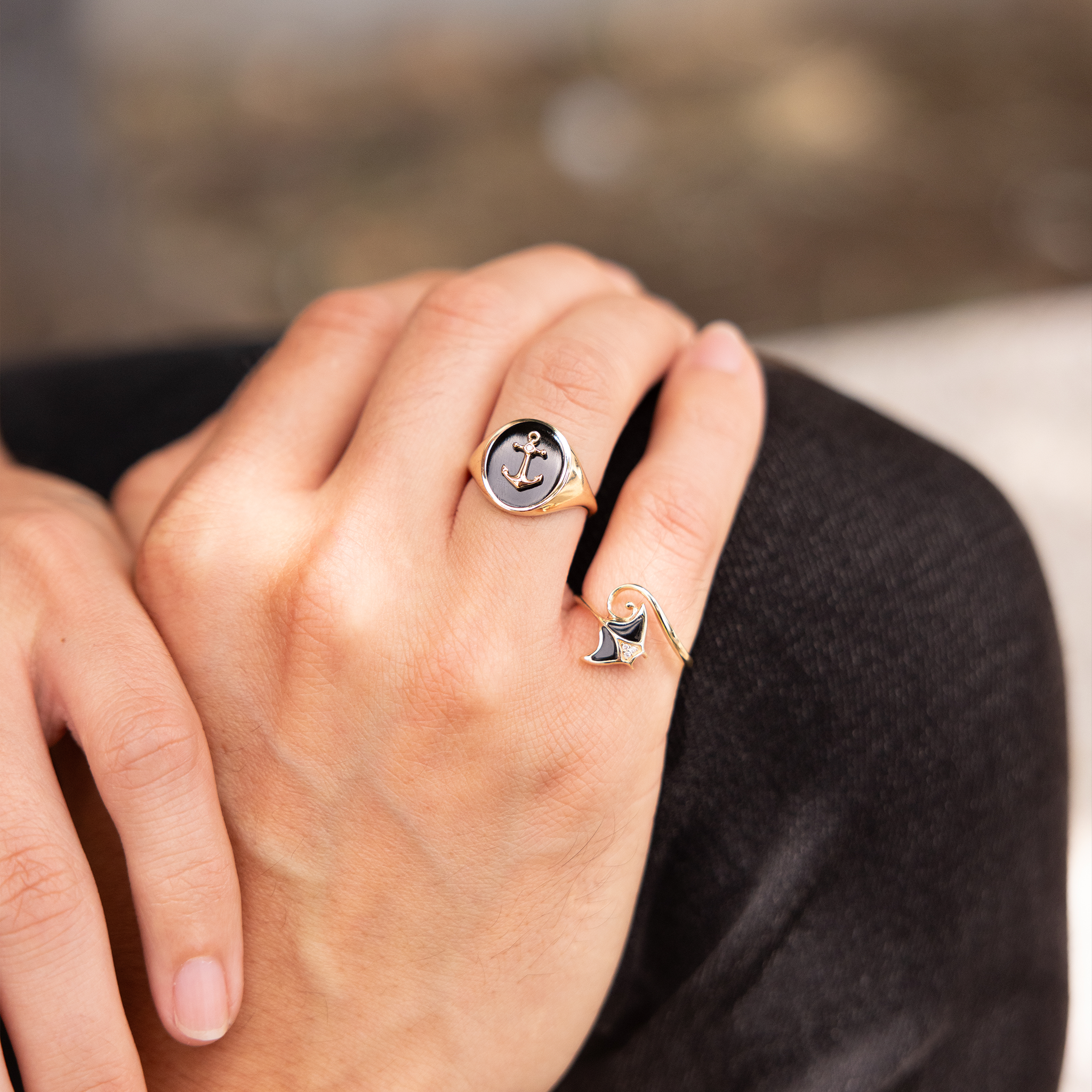 Close up hand wearing Sealife manta ray and Anchor Black Coral Signet Ring in Gold with Diamond