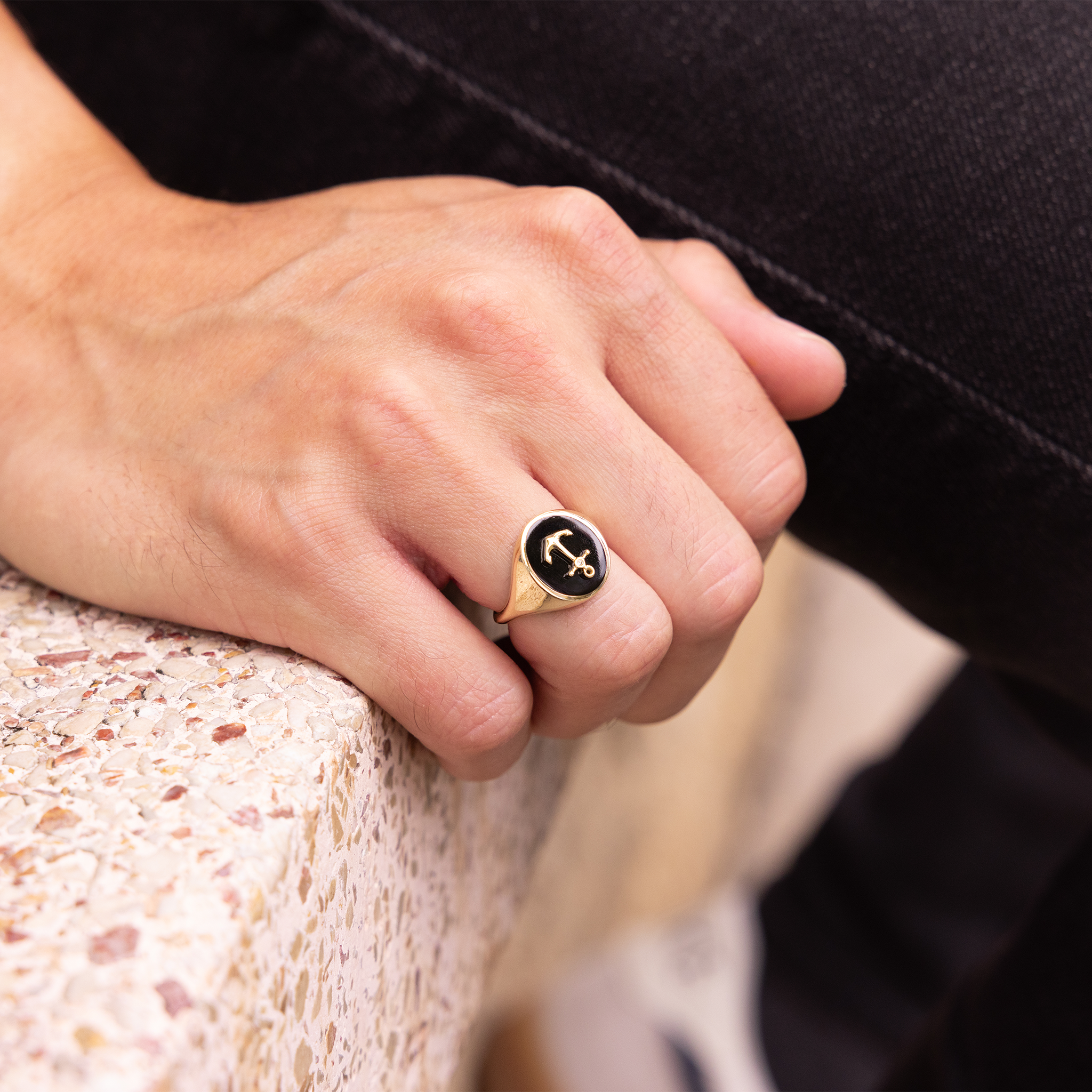 Close up of hand wearing Sealife Anchor Black Coral Signet Ring in Gold with Diamond