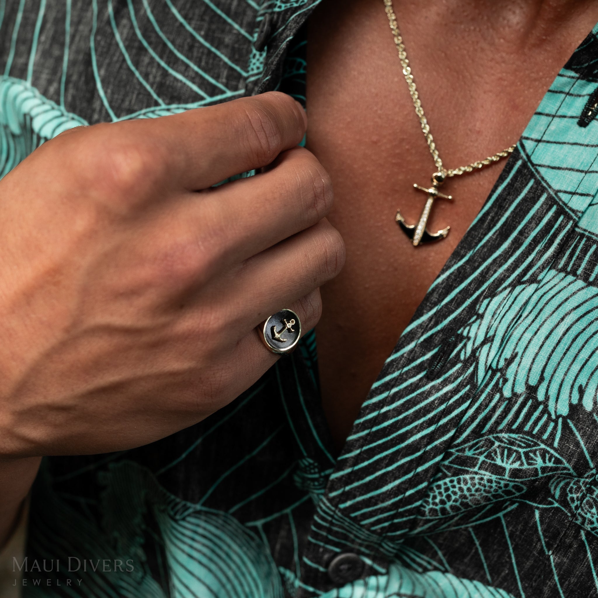 Close up of man wearing Sealife Anchor Black Coral Signet Ring and pendant in Gold with Diamond