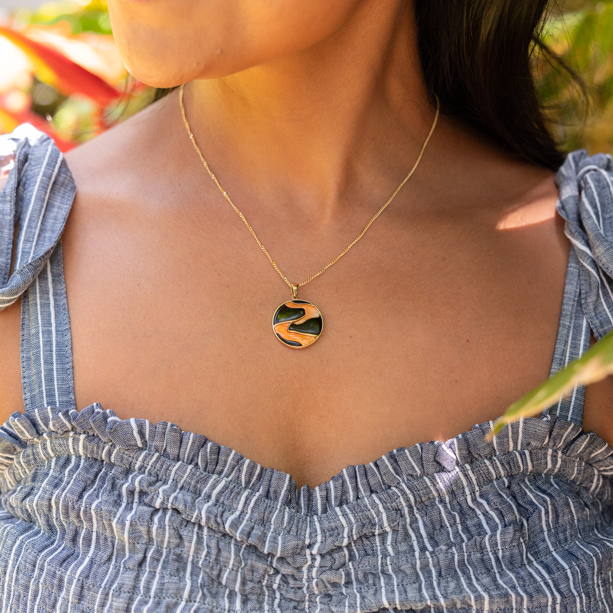 Lava Flow Black Coral and Spiny Oyster Pendant on woman's neckline