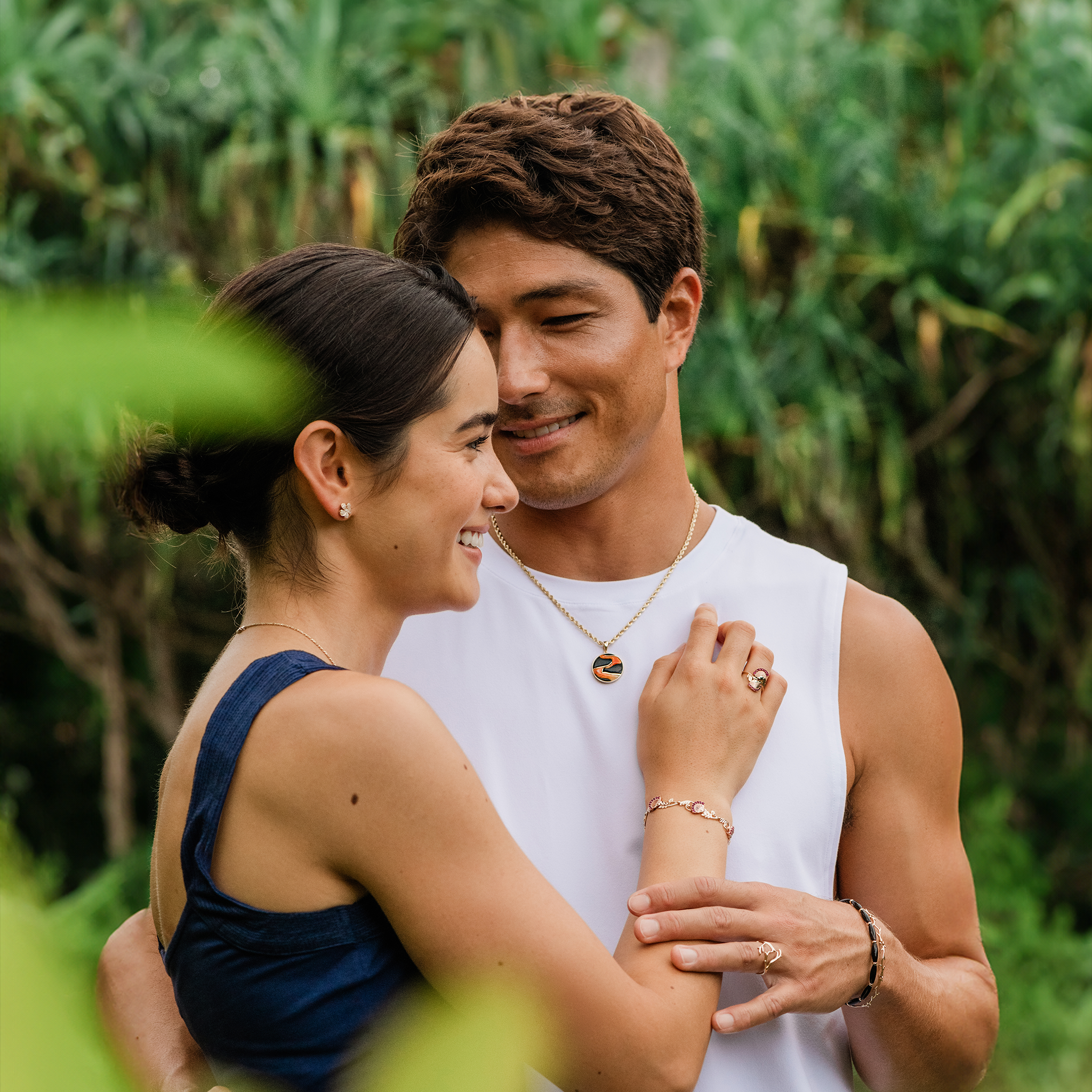 Couple embracing with man wearing Lava Flow Black Coral and Spiny Oyster Pendant