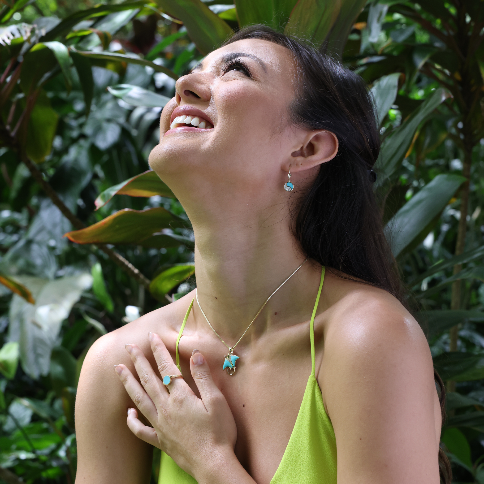 Woman in garden wearing Yin Yang Turquoise Earrings in Gold with Diamonds