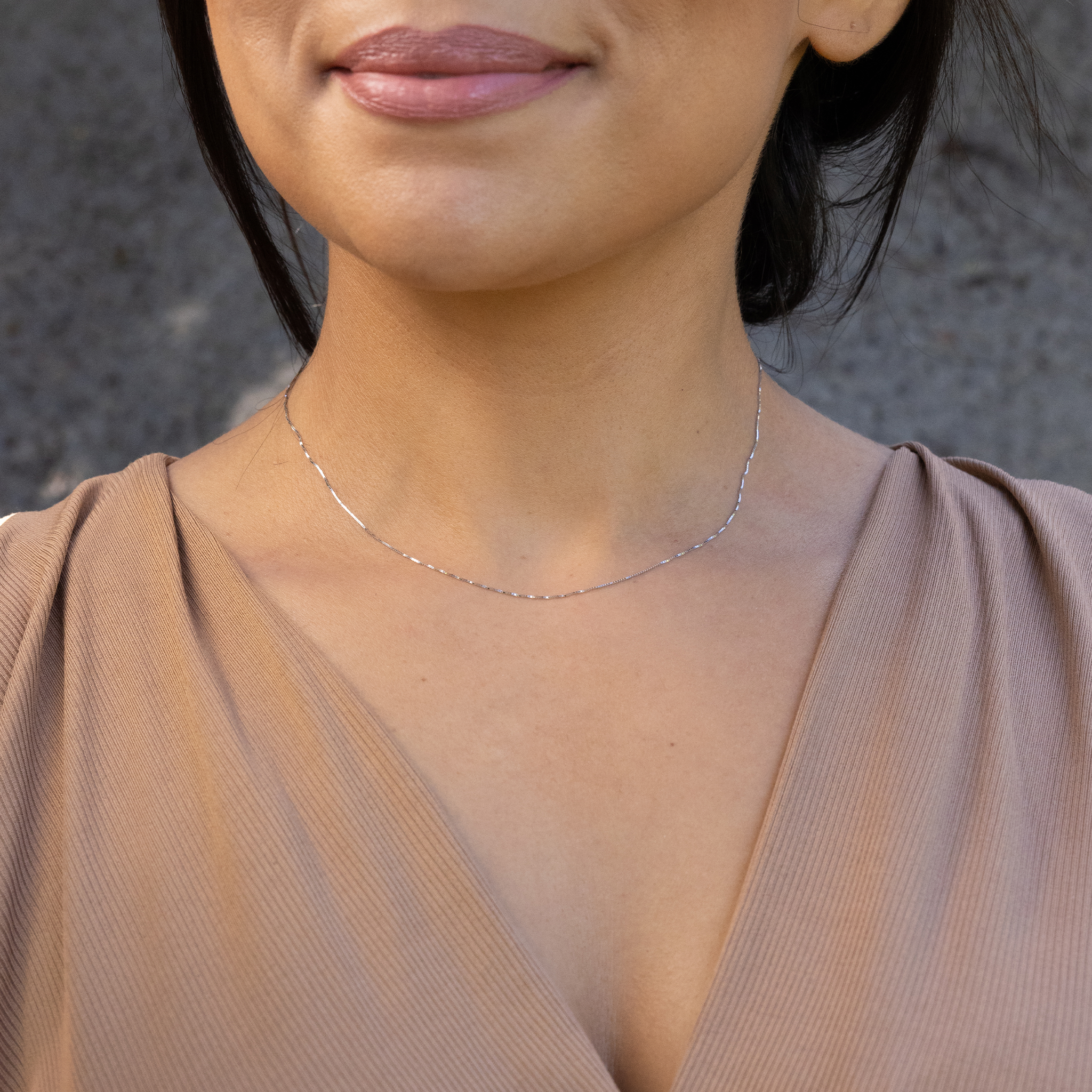 Close up of 0.6mm Box Chain in 10k White Gold on woman's chest