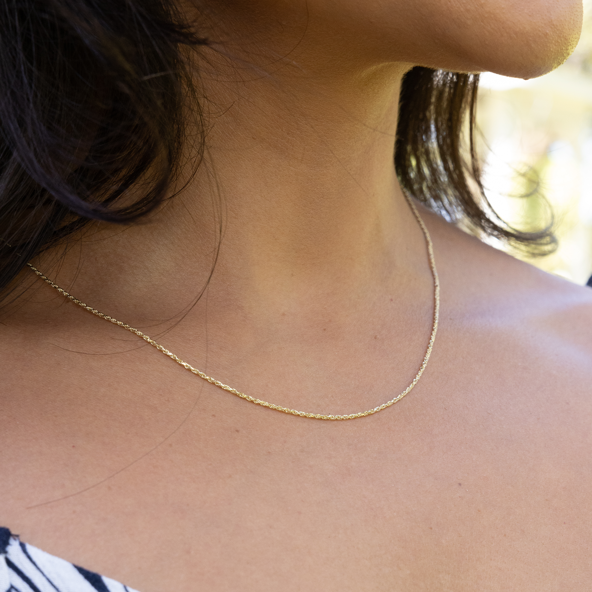 Close up of 1.2mm Flex Rope Chain in Gold on woman's chest