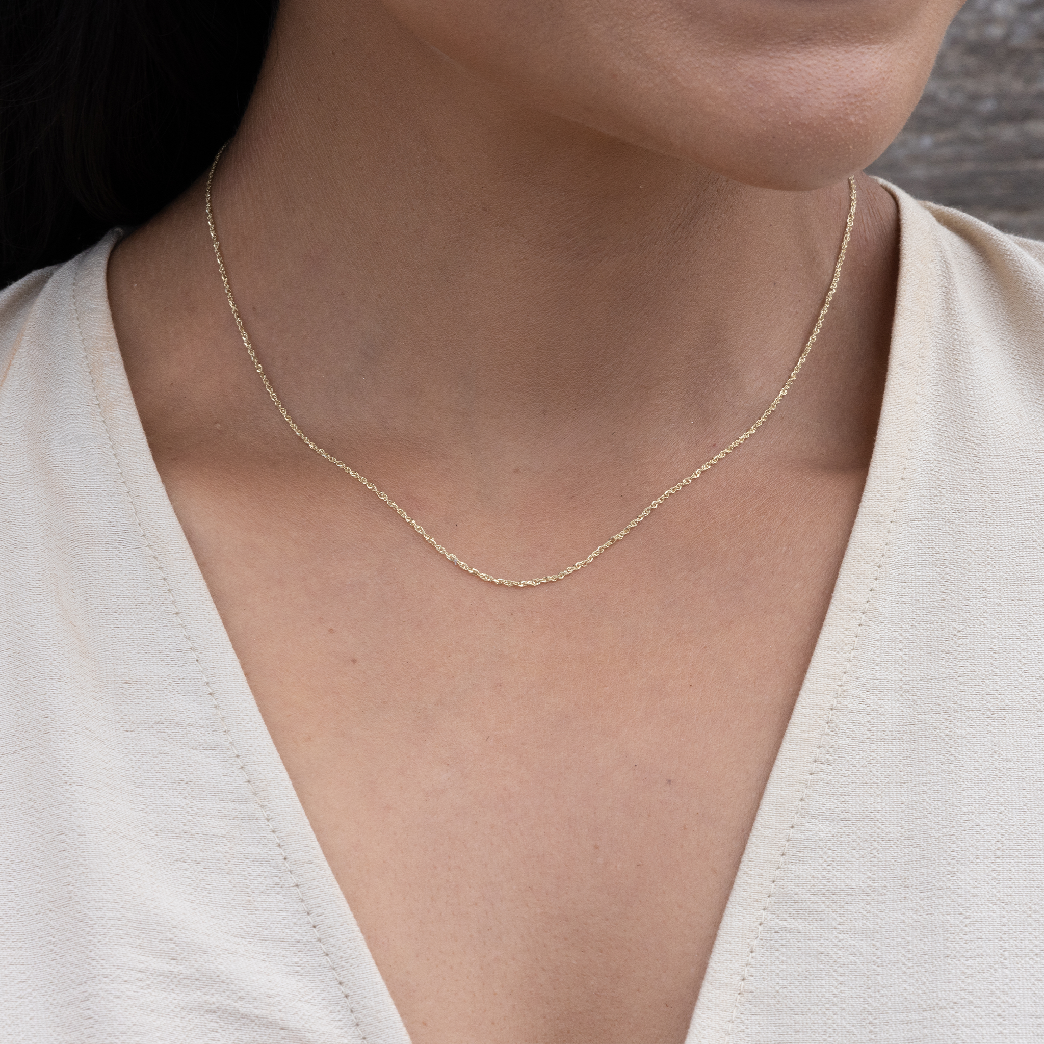 Close up of 0.8mm Baby Rope Chain in Gold on neckline