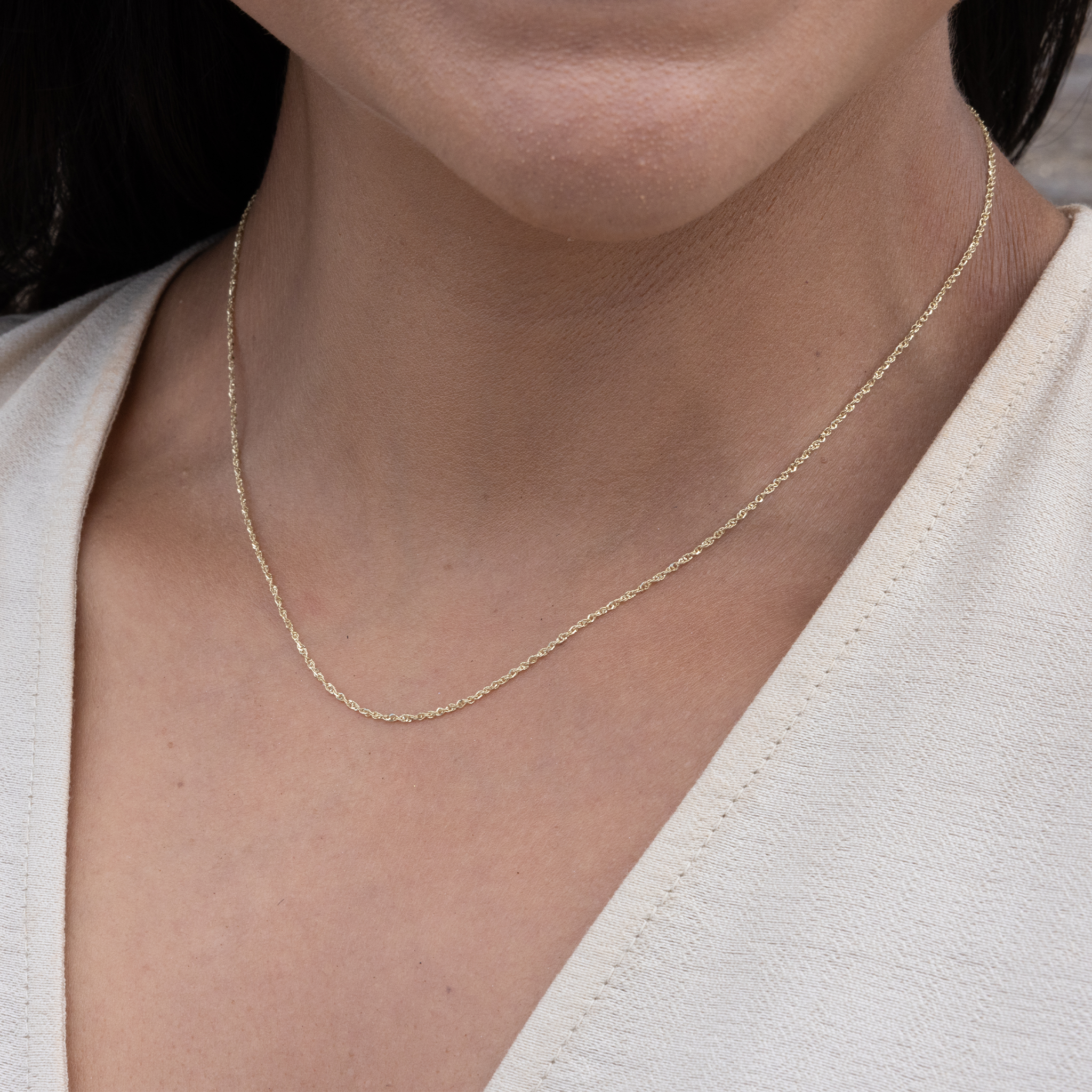 Close up of 0.8mm Baby Rope Chain in Gold on neckline