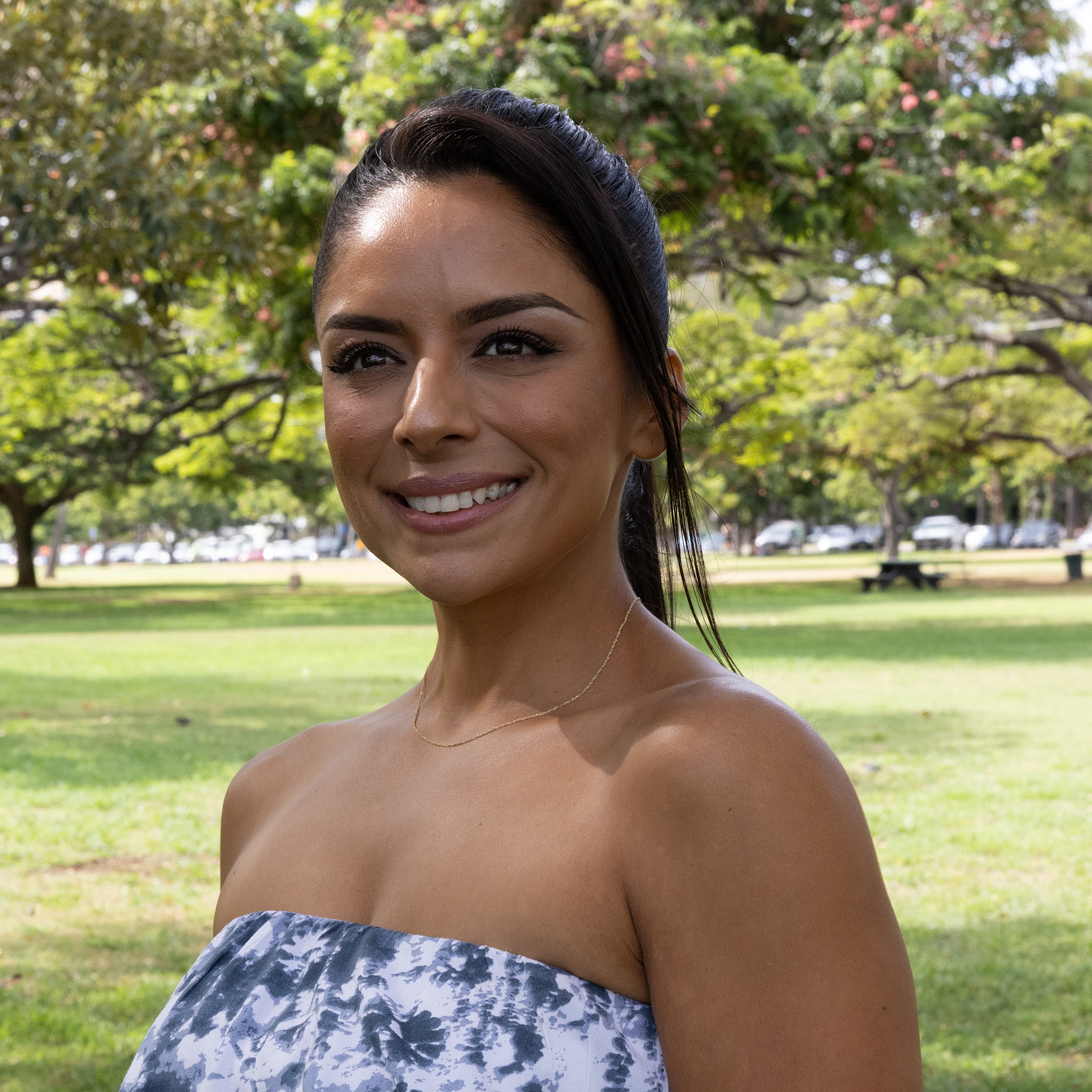 Woman in a park wearing 0.8mm Baby Rope Chain in Gold