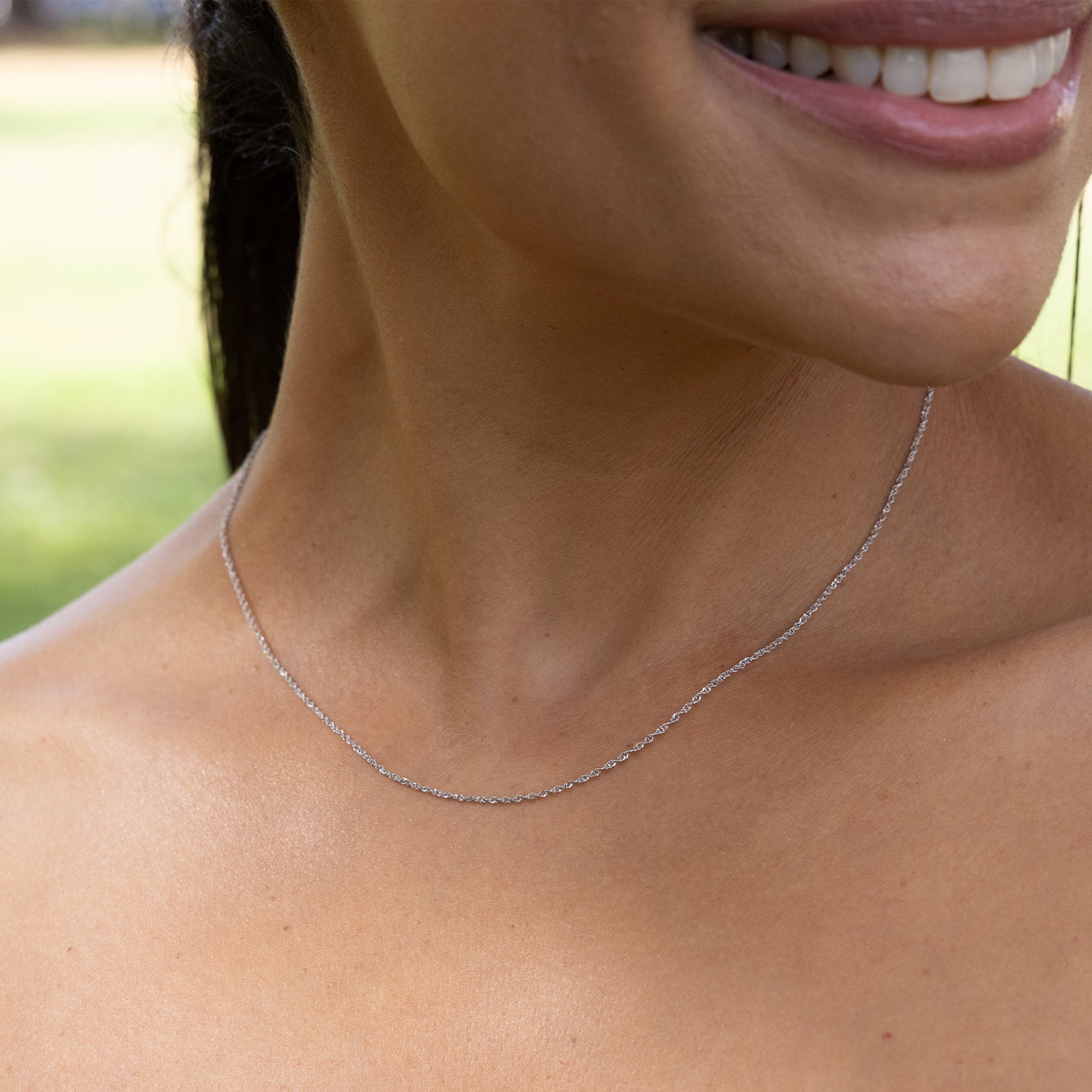 Close up of 0.8mm Baby Rope Chain in White Gold on woman's neckline