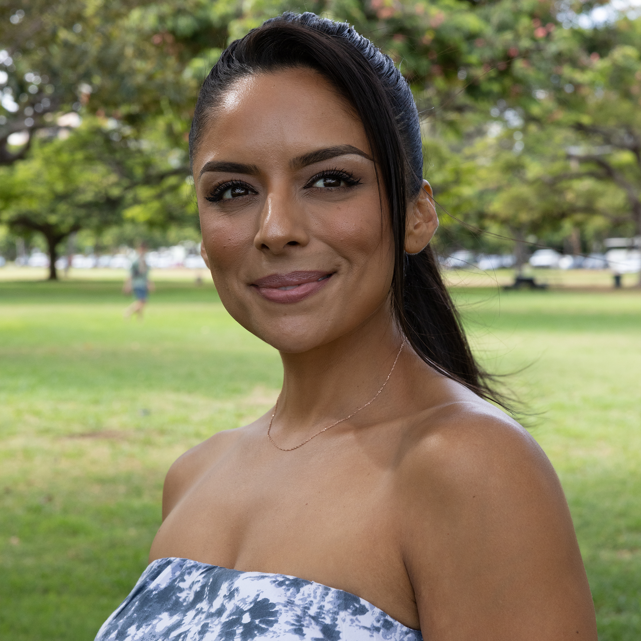 Woman at the park wearing 0.8mm Baby Rope Chain in Rose Gold