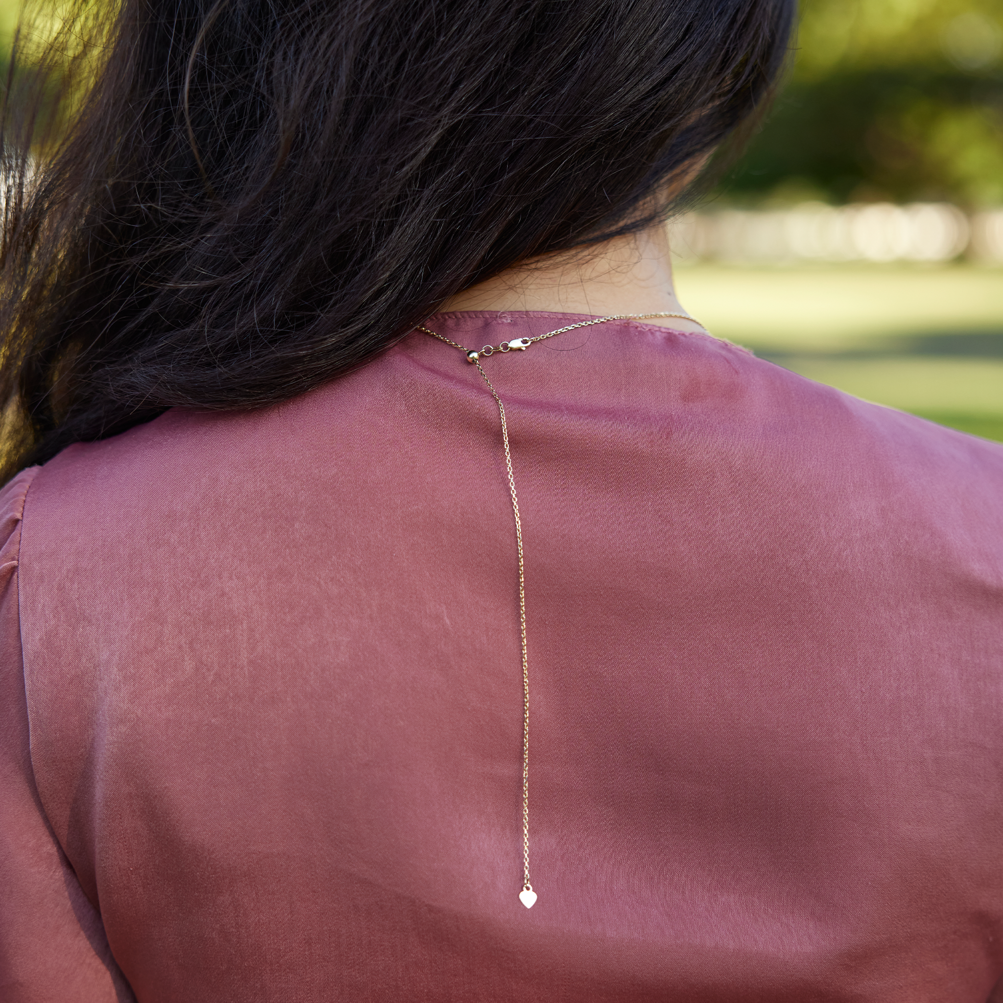 Adjustable detail of 1.0mm Cable Chain in 14k Yellow Gold on woman's neck