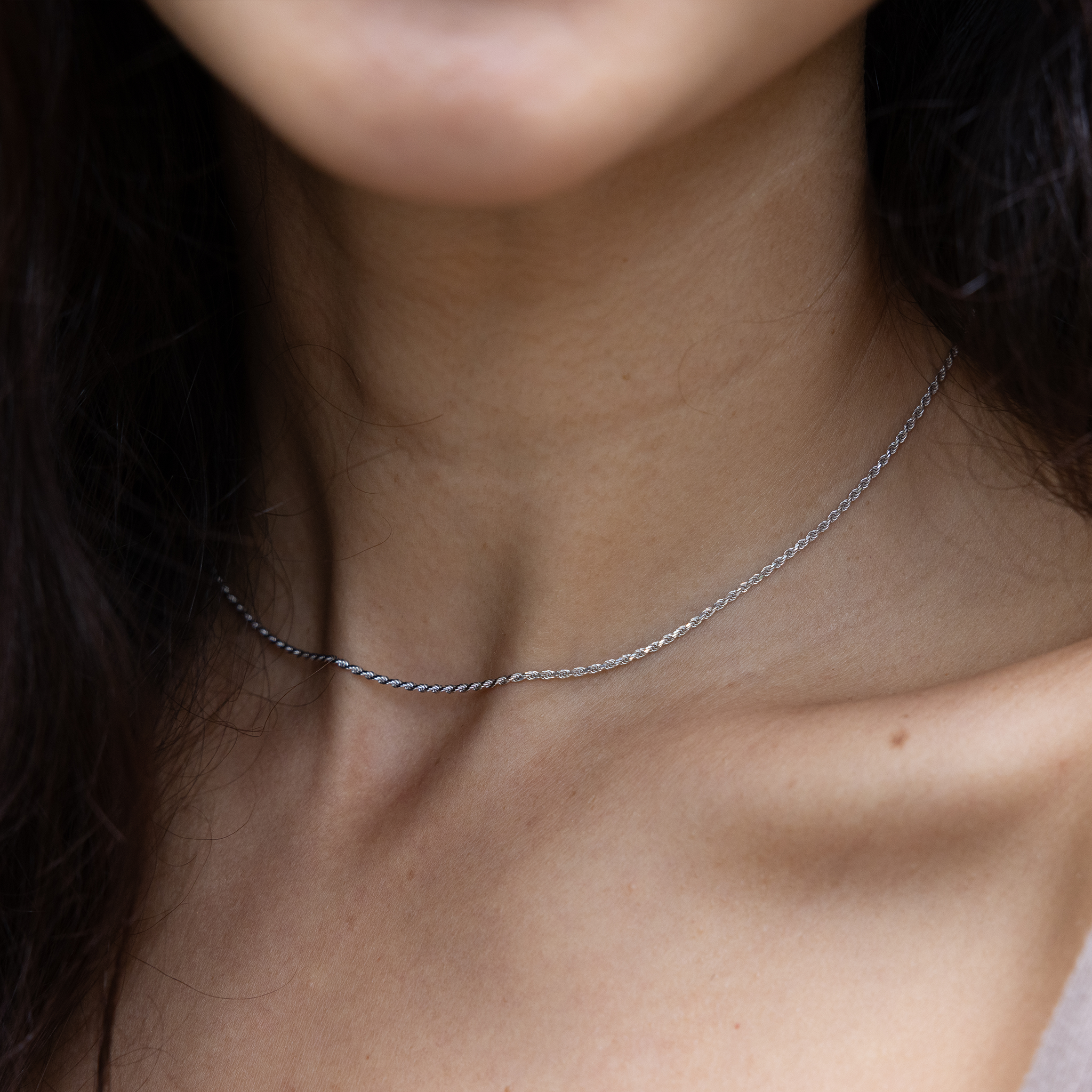 Close up of 1.2mm Flex Rope Chain in White Gold on a woman's neckline
