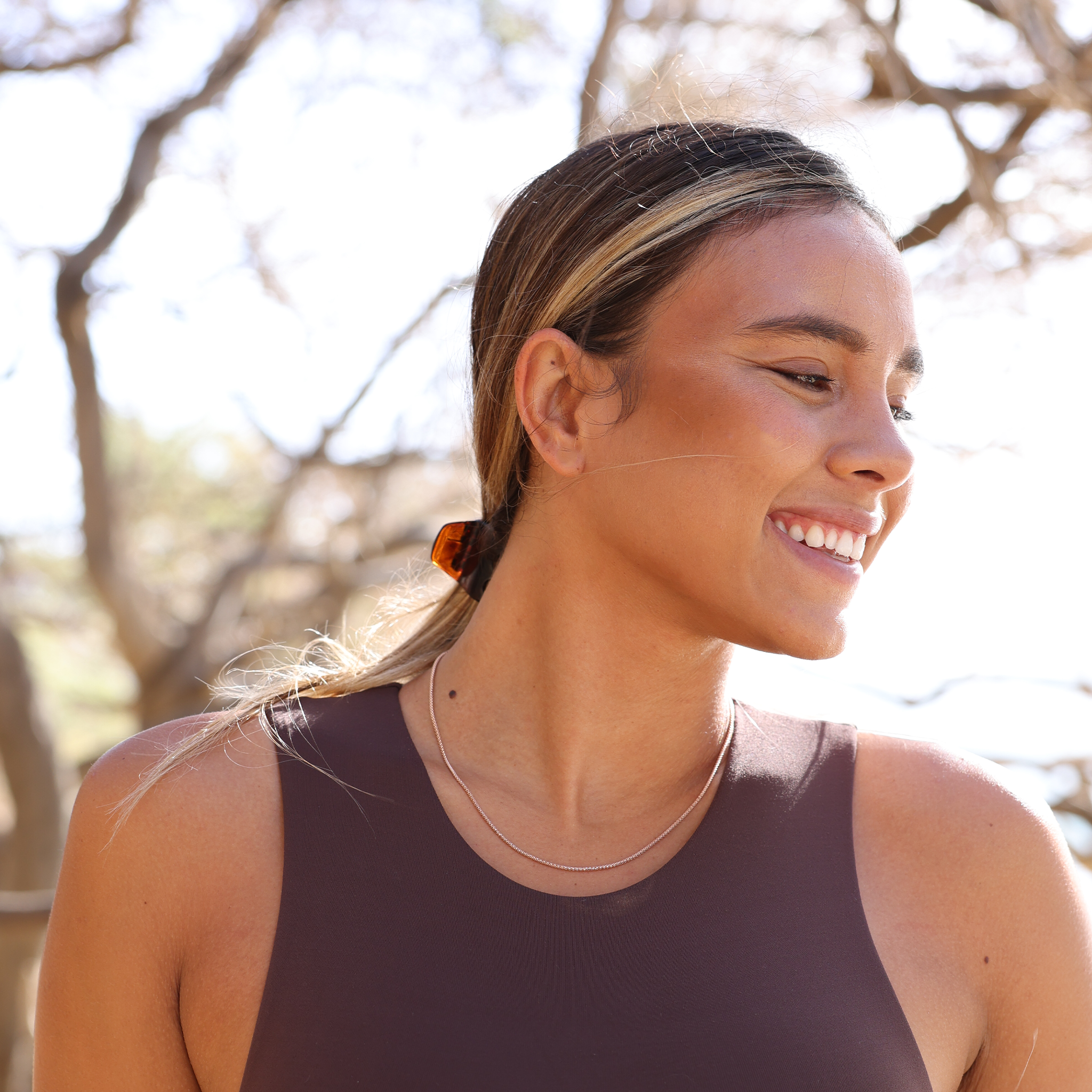 Woman outdoors wearing 1.6mm Popcorn Chain in 14k Rose Gold
