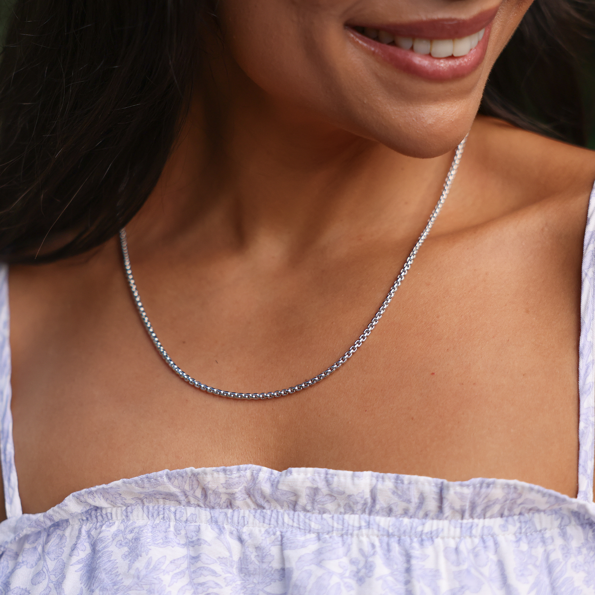 Close up of a womanʻs neckline wearing 2.5mm Round Box Chain in Sterling Silver