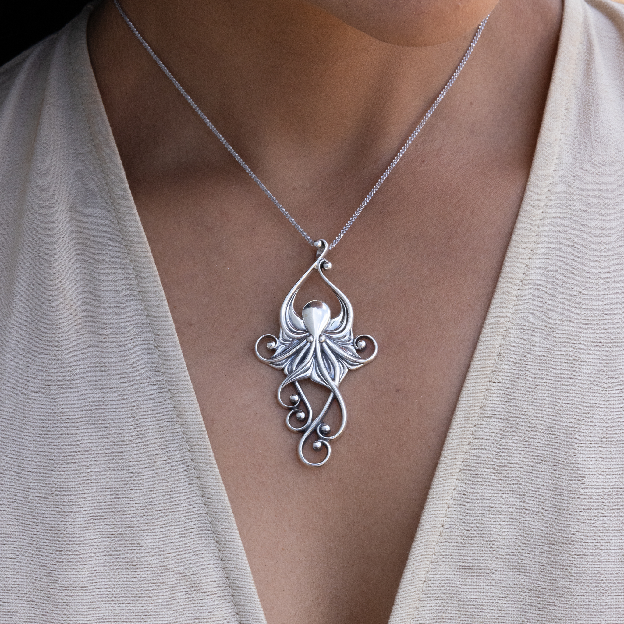 Close up of Living Heirloom Octopus Pendant in Sterling Silver on a woman's chest