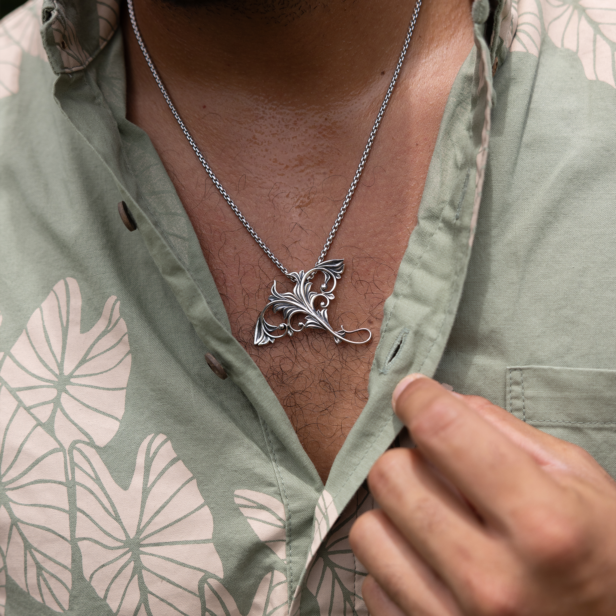 Close up of a Living Heirloom Manta Ray Pendant in Sterling Silver on a man's chest