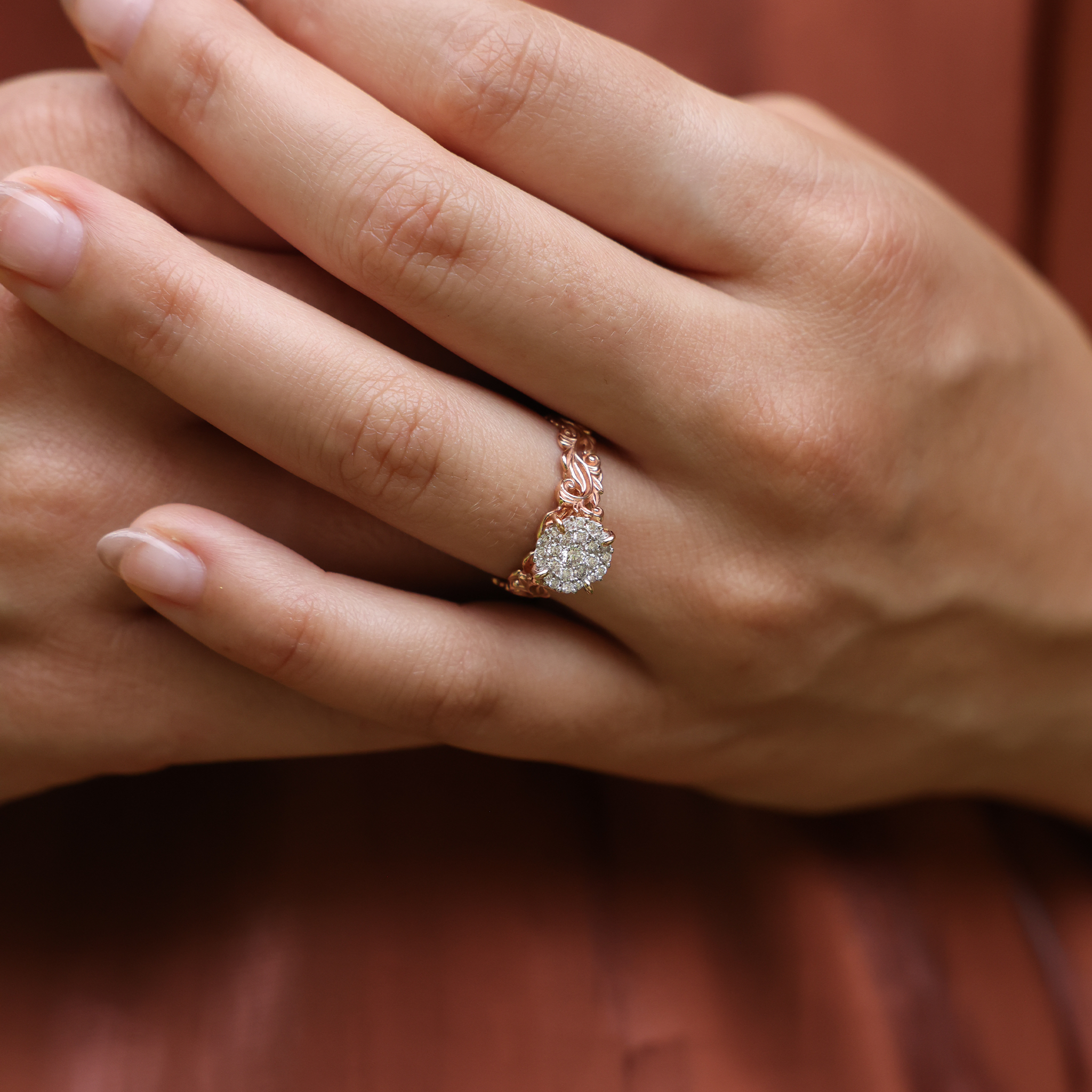 Close up of Living Heirloom Engagement Ring in Rose Gold with Diamonds on a woman's hand