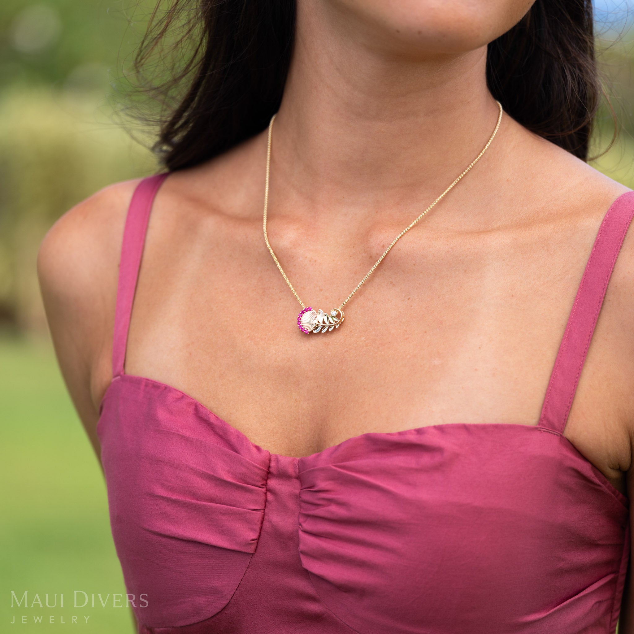 Close up of ʻŌhiʻa Lehua Ruby Pendant in Two Tone 14k Gold with Diamonds.