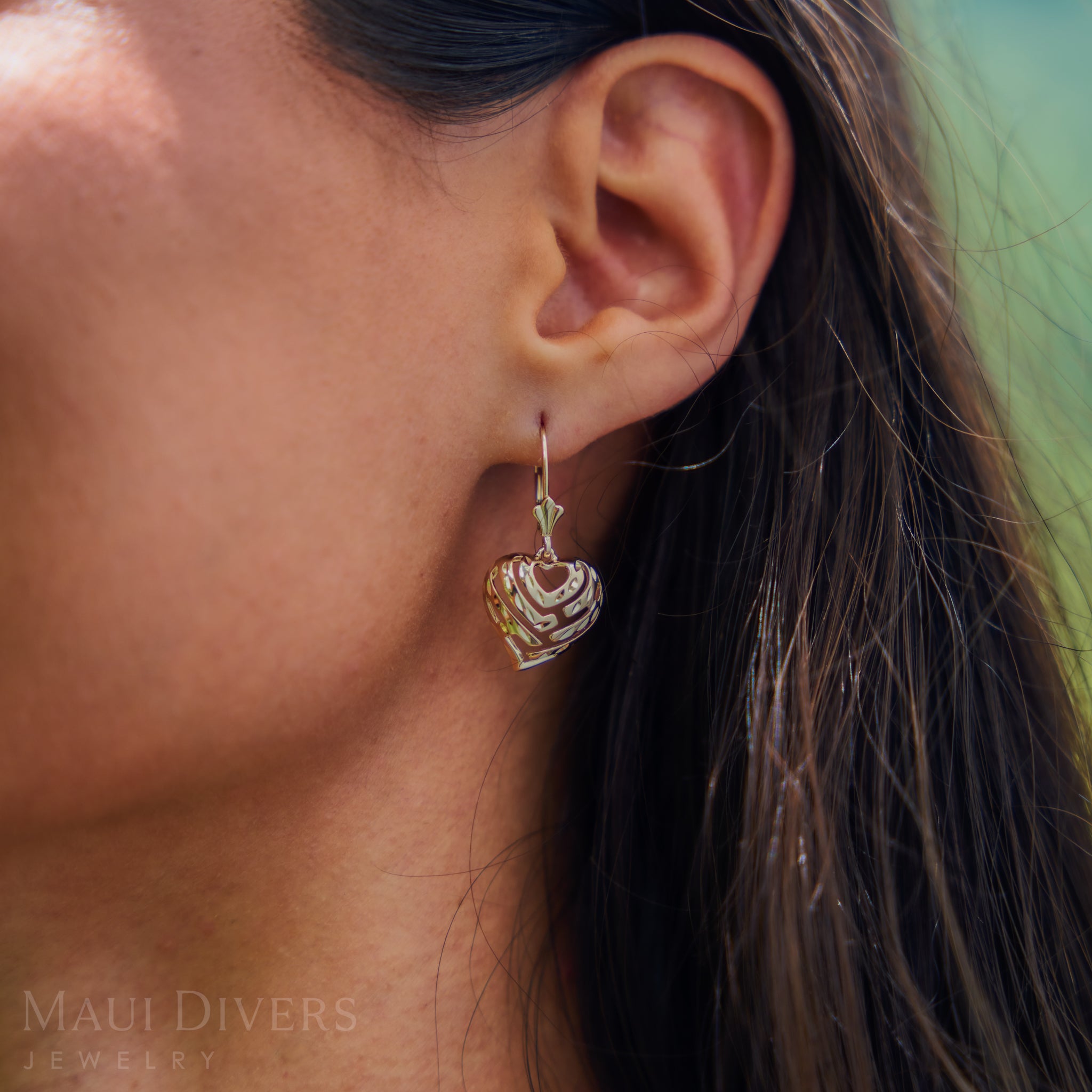 Close-up of a 15mm Aloha Heart Fleur de Lis Leverback Earrings in 14k Yellow Gold