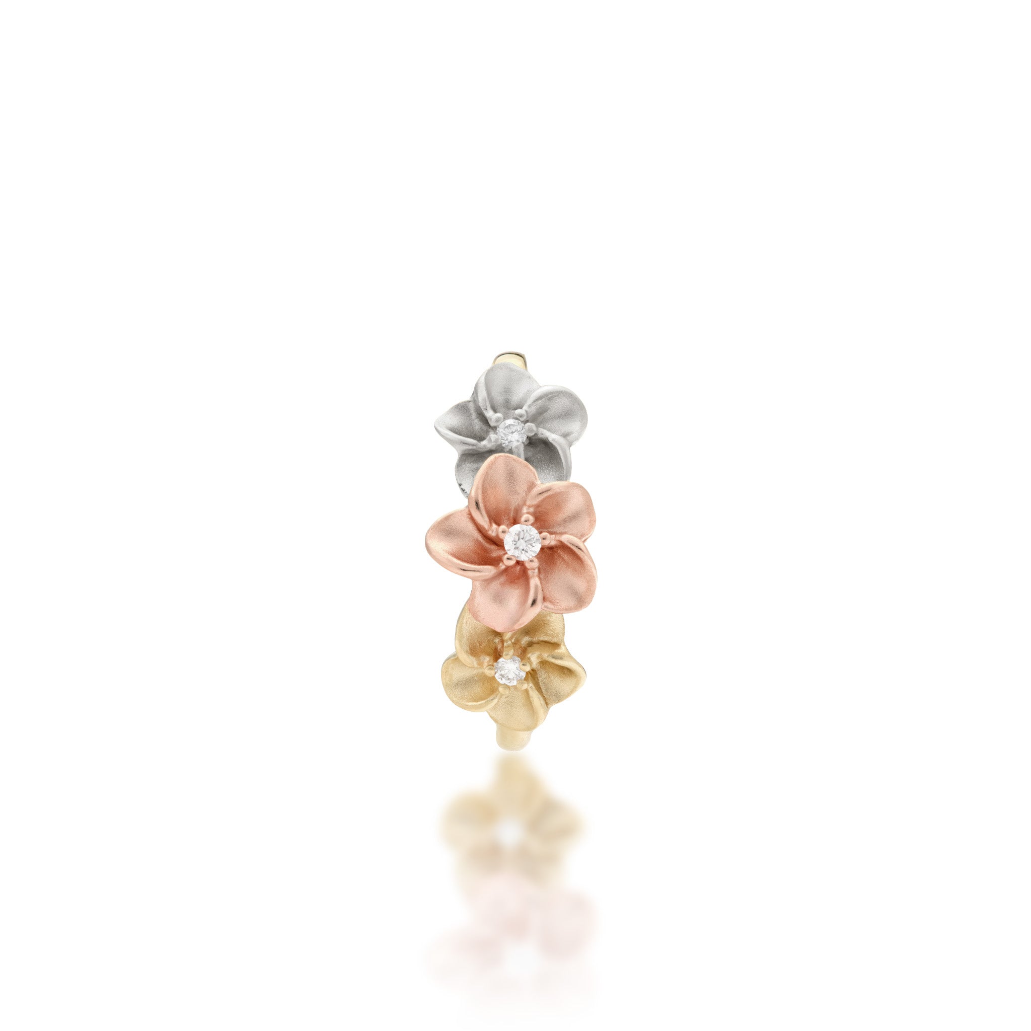 Top view of the 8mm Three Plumeria Ring in Tri Color Gold with Diamonds on a white background