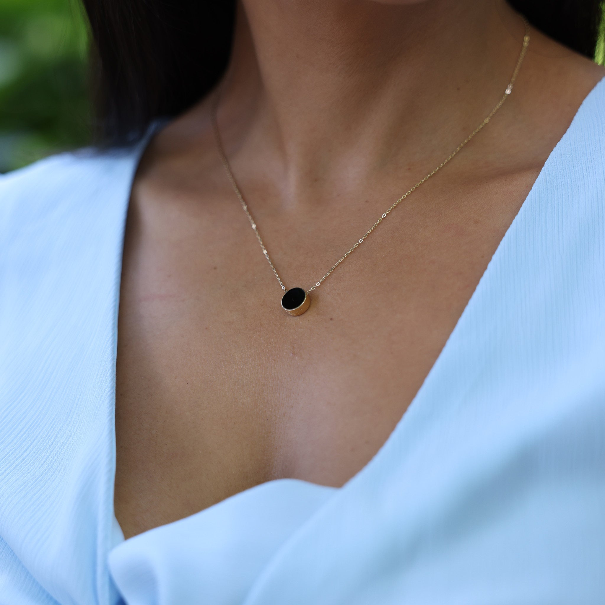 Close up of woman wearing Eclipse Flipside Black Coral & Mother of Pearl Necklace in Gold