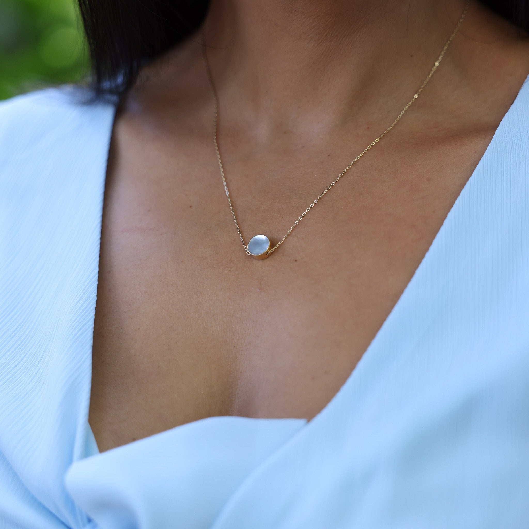 Close up of woman wearing Eclipse Flipside Black Coral & Mother of Pearl Necklace in Gold