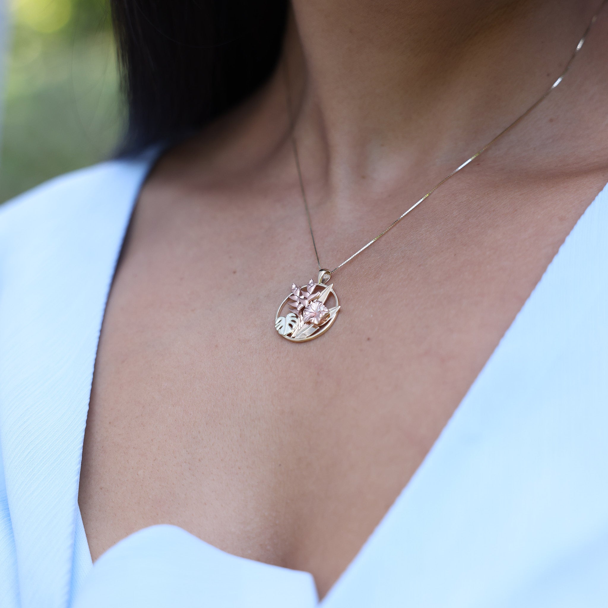close up of woman wearing Hawaiian Gardens Hibiscus Pendant in Tri Color Gold with Diamonds - 20mm