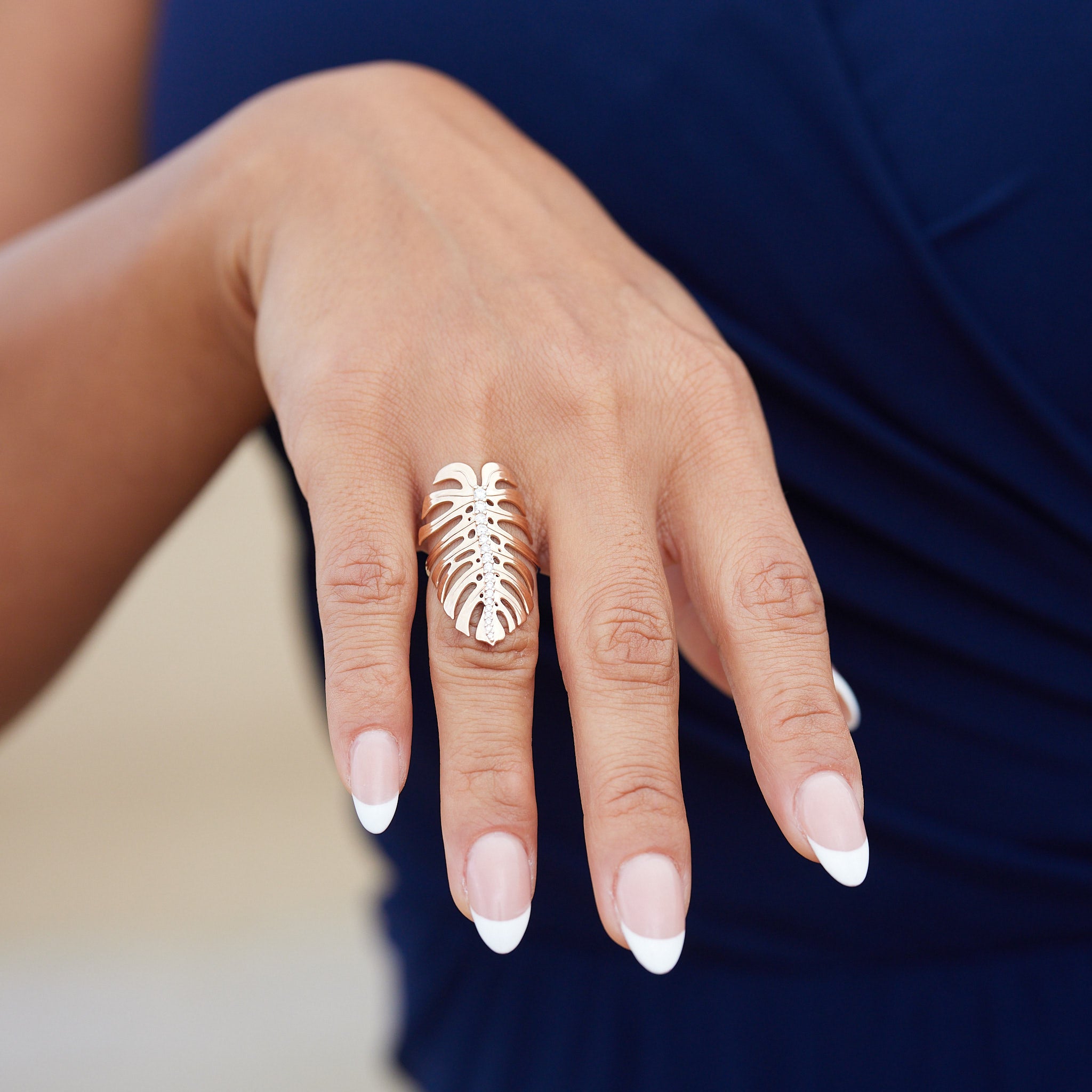 32mm Monstera Ring in Rose Gold with Diamonds on a woman holding her hand out