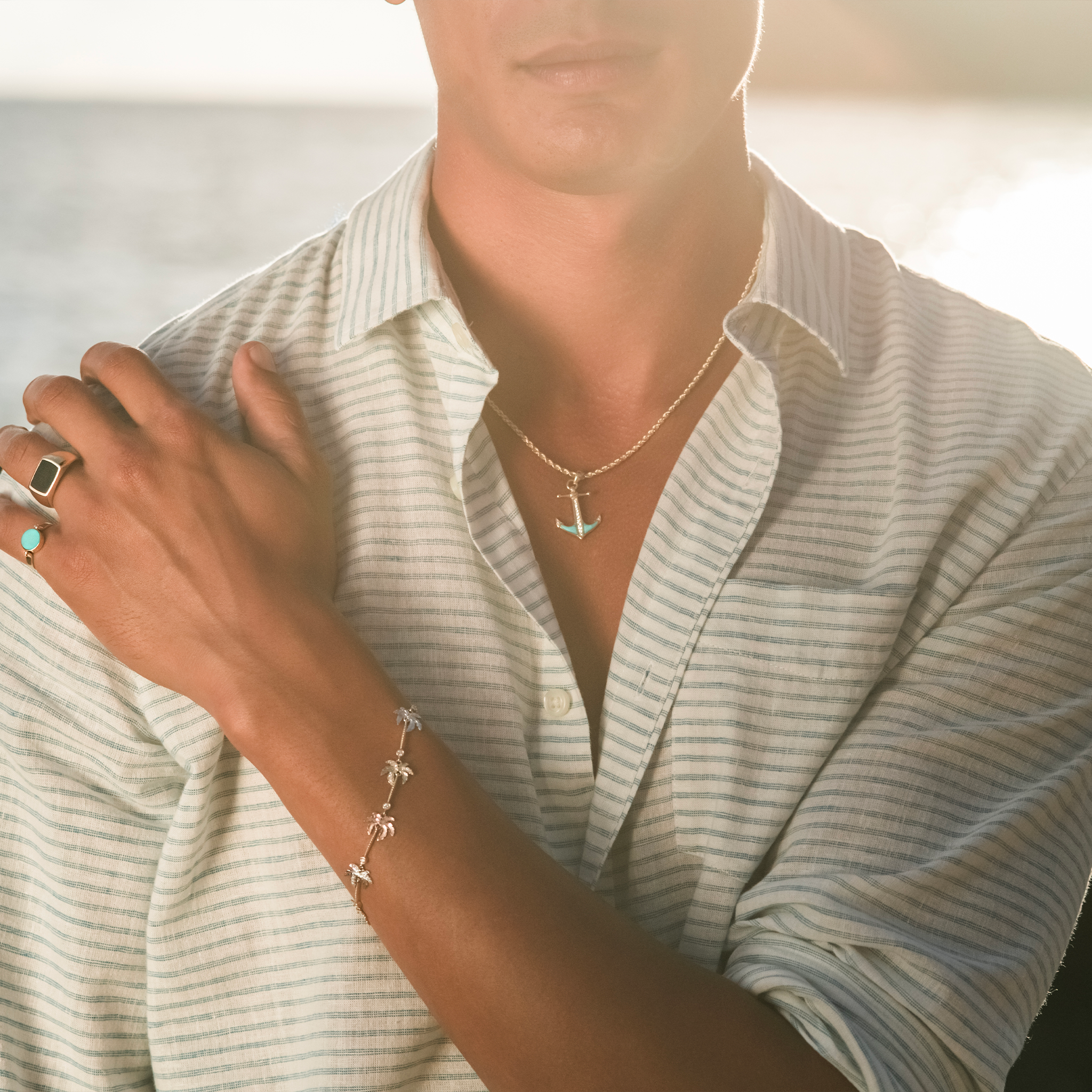 Close up of man by ocean at sunrise wearing a 2.5mm Rope Chain in 14k Yellow Gold